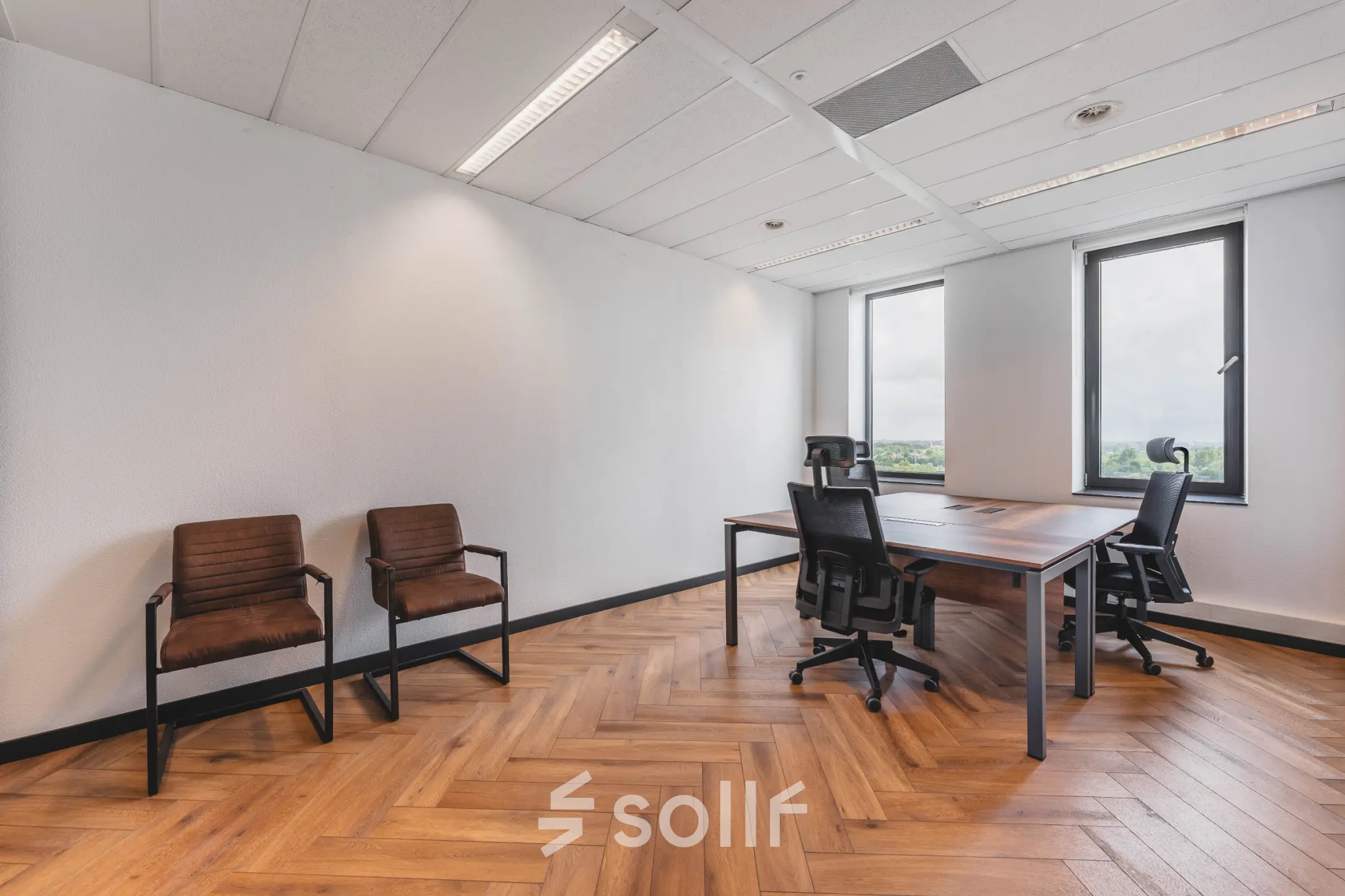 A furnished office space with a meeting table and chairs, located at Laan van Zuid Hoorn 70, ideal for office space rental.