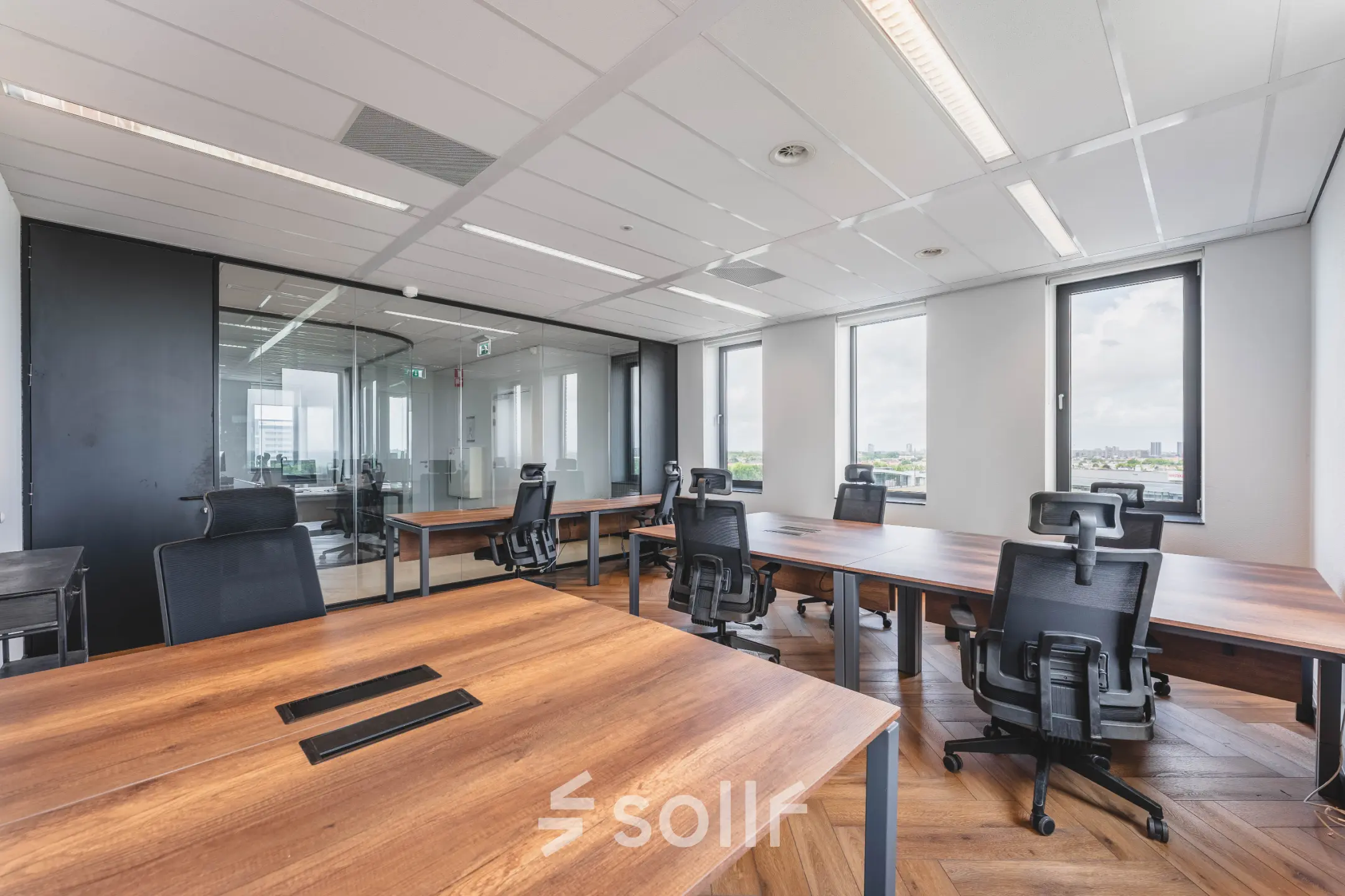 Office space for rent at Laan van Zuid Hoorn 70, Rijswijk, featuring modern workstations with ample natural light and city views. Ideal for office space rental.