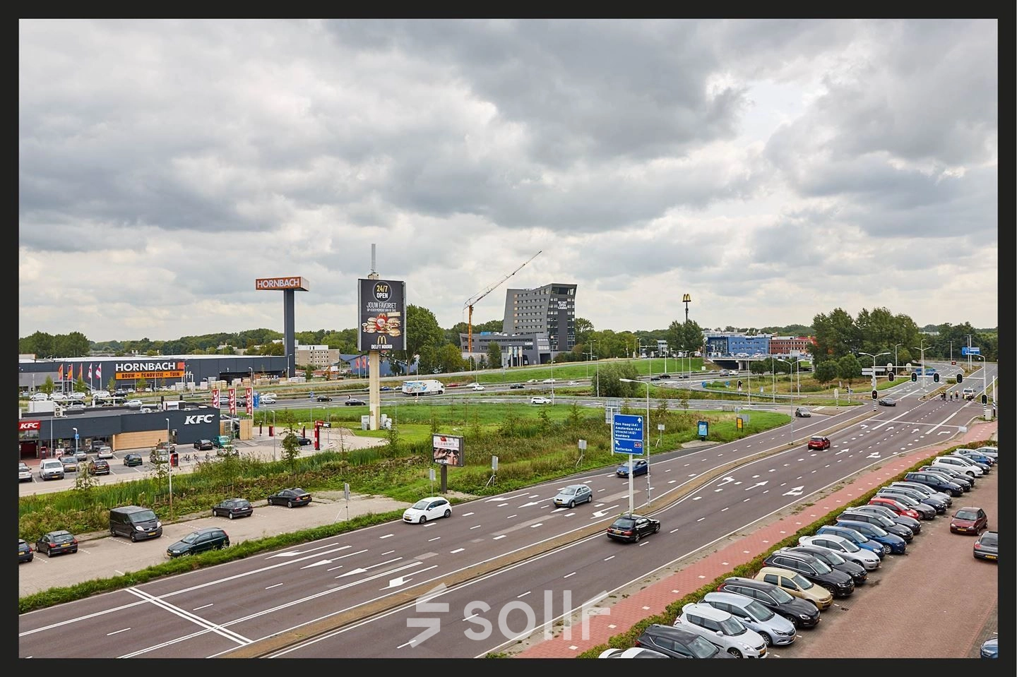 Exterior view near Patrijsweg 62 in Rijswijk, showcasing nearby businesses and ample parking space, ideal for those exploring office space rental options.