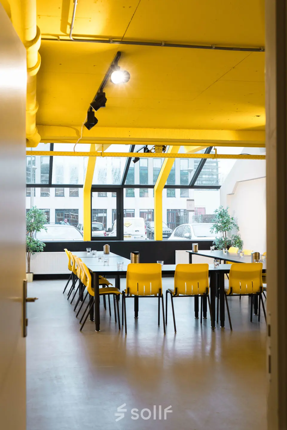 Bright office space with yellow ceiling and large windows at Volmerlaan 7, Rijswijk, available for rent. Suitable for meetings and collaboration.