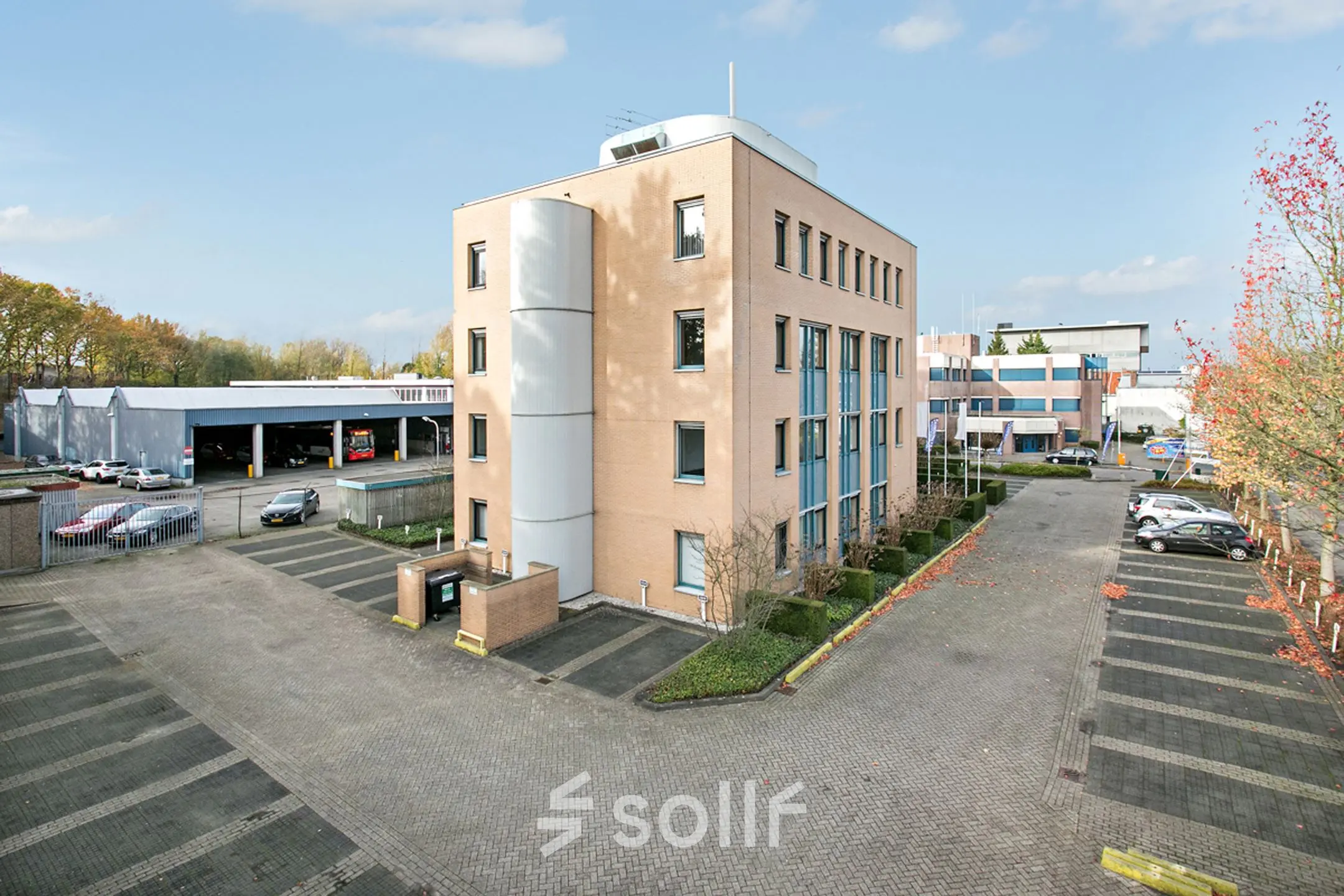 Exterior view of office building at Laan van Brabant 70-86, Roosendaal, showing parking space and adjacent facilities. Ideal for rent office space needs.