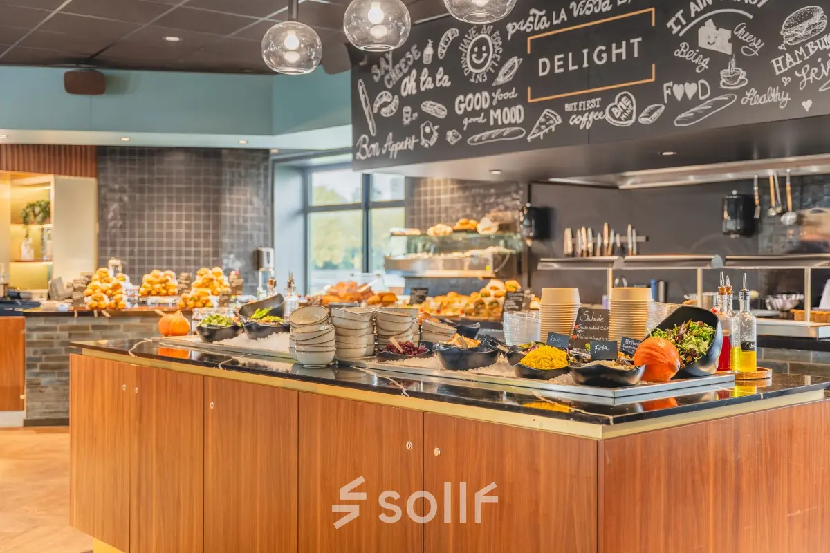 Inviting office pantry area with a buffet of food items, pumpkins, and decorative elements, ideal for a comfortable workspace experience.
