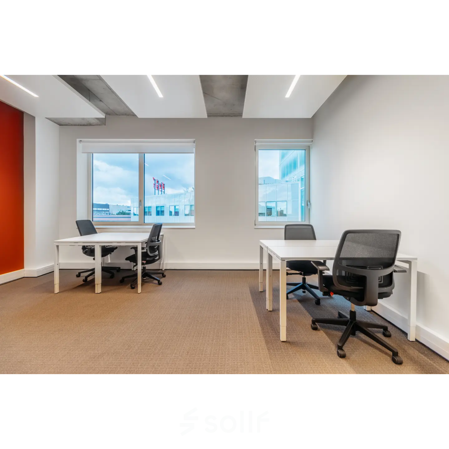 Interior of an office space at Marten Meesweg 25-G, Rotterdam Alexander with desks and chairs facing bright windows. Ideal for office space rental.
