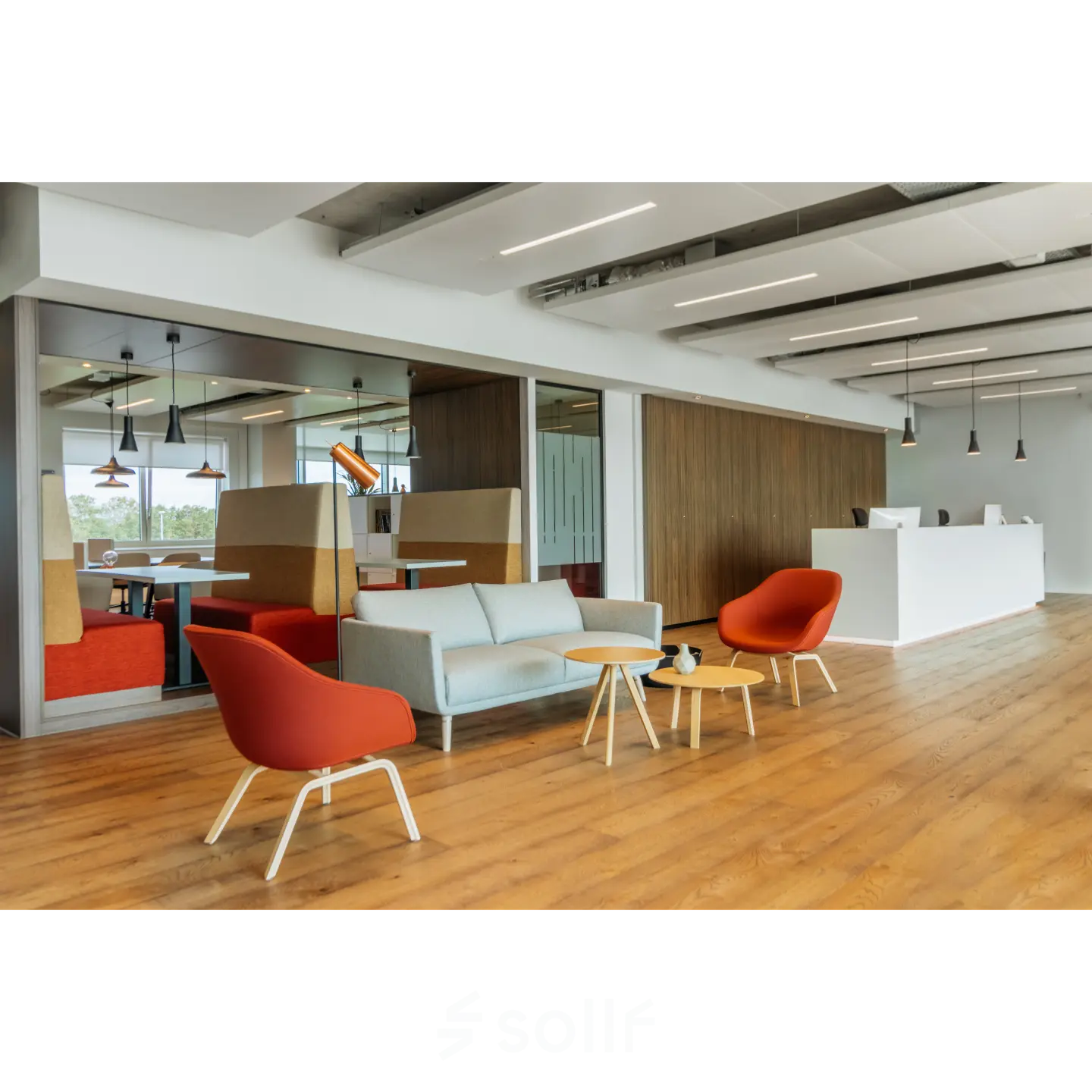 Modern office space for rent in Rotterdam Alexander with a stylish lounge area, featuring colorful chairs and wooden tables; perfect for casual meetings or relaxation.