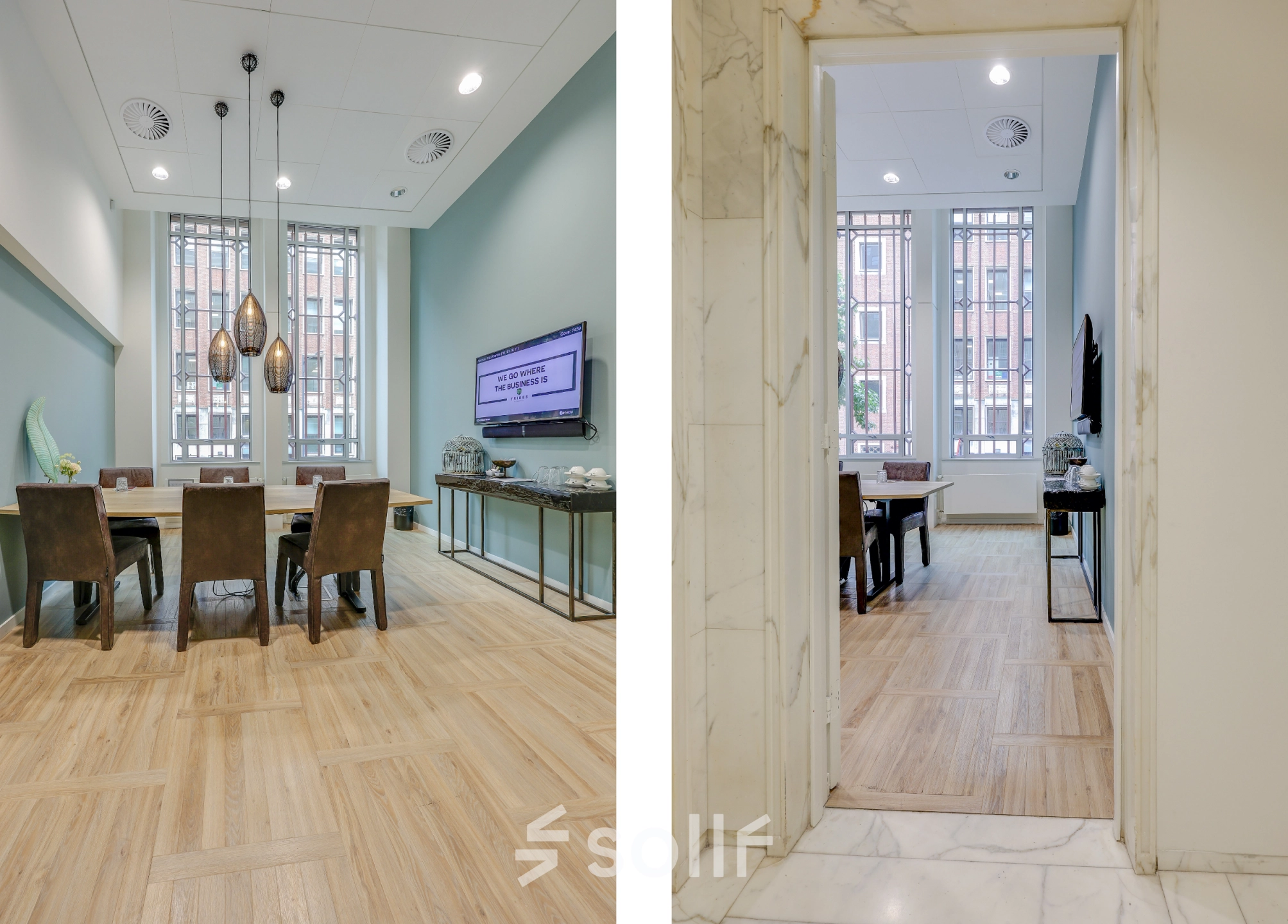 Bright office to rent at Blaak 34, Rotterdam Center features a conference room with a large table, chairs, modern lighting, and a TV. Ideal for office space rental.