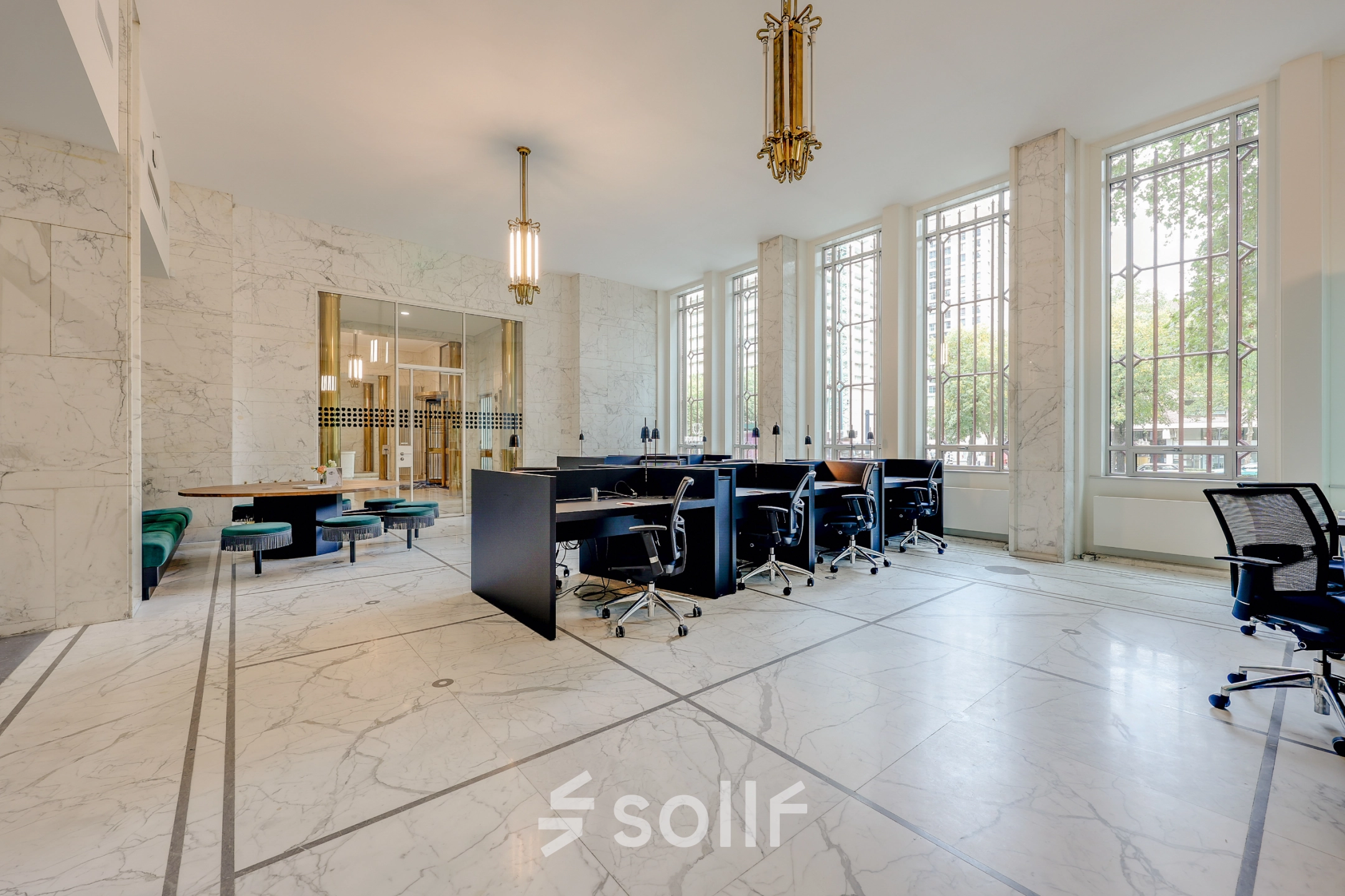 Bright office space with marble flooring and modern furnishings, available for rent at Blaak 34, Rotterdam Center. Large windows enhance the workspace's appeal for office space rental.