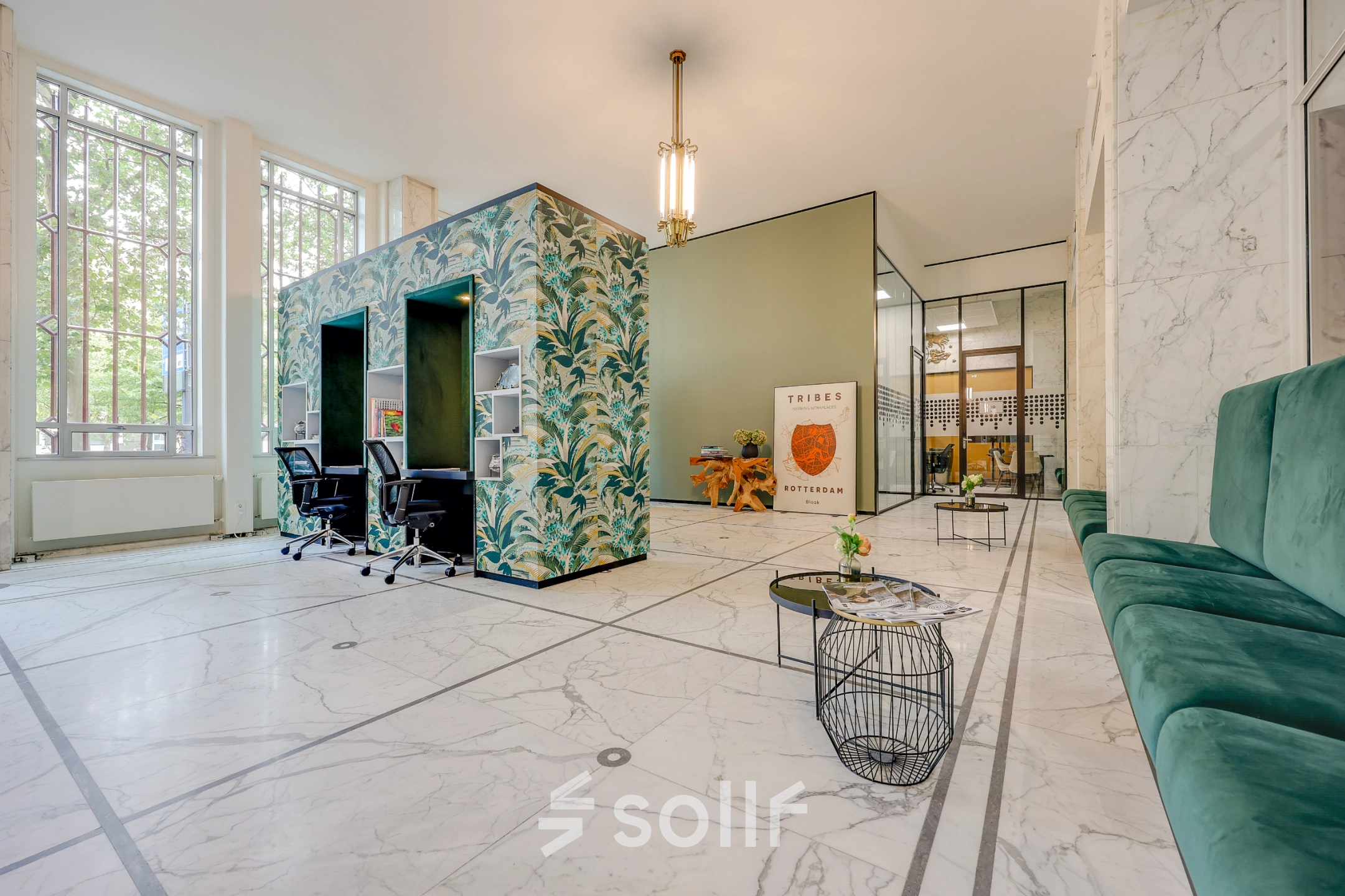 Spacious office to rent at Blaak 34, Rotterdam Center featuring modern decor with accent walls, seating area, and ample natural light for a vibrant work environment.