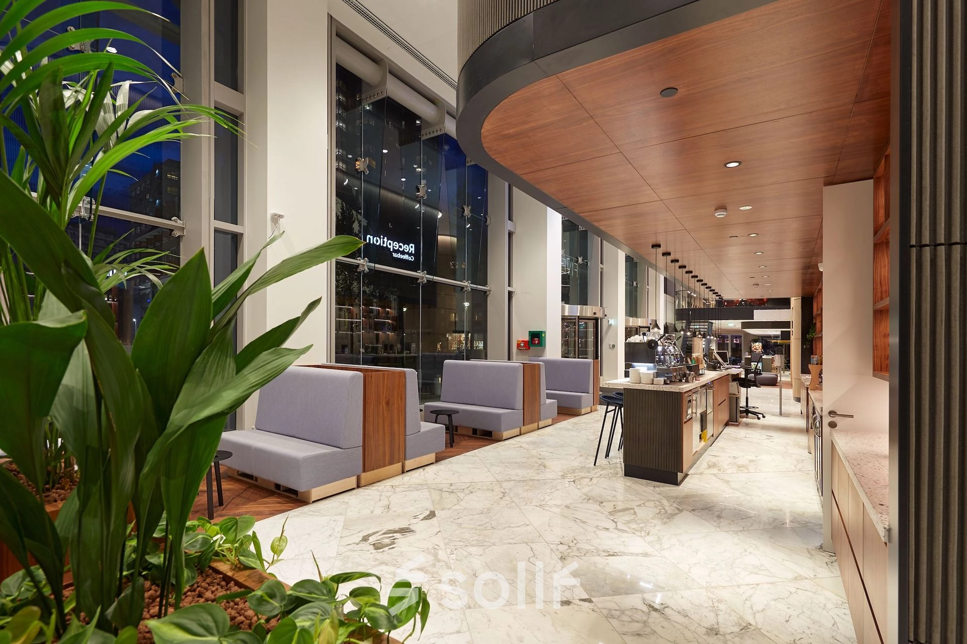 Spacious office at Blaak 555, Rotterdam Center, featuring modern furnishings and a well-lit open floorplan. Ideal for office space rental seekers.