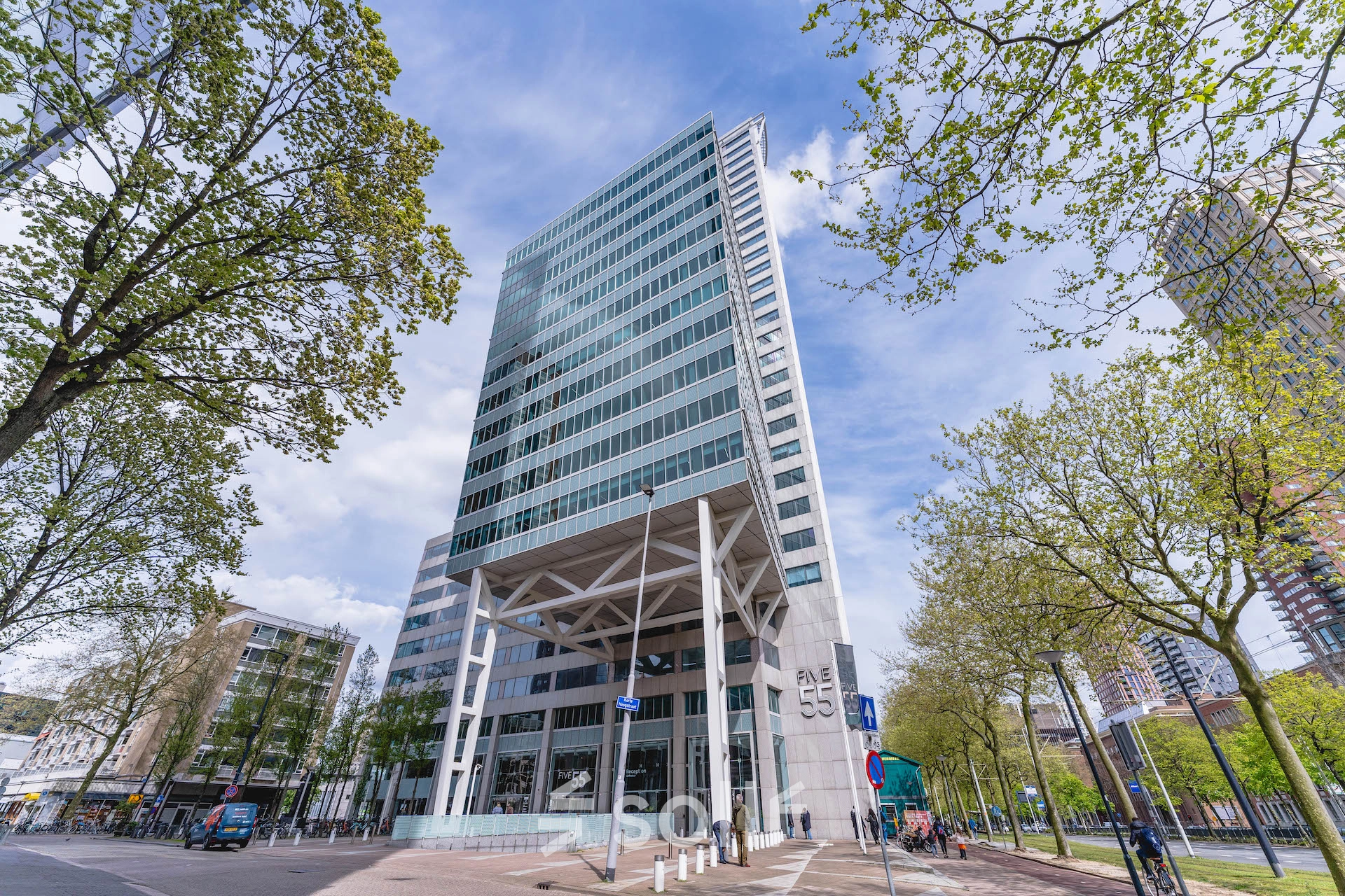 A modern high-rise office building located at Blaak 555 in Rotterdam Center, ideal for those seeking office space rental in the city.