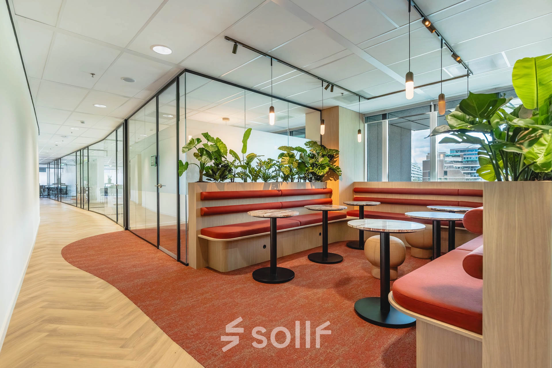 Modern furnished office space at Blaak 555, Rotterdam Center, featuring stylish seating areas and greenery. Ideal office space rental opportunity.