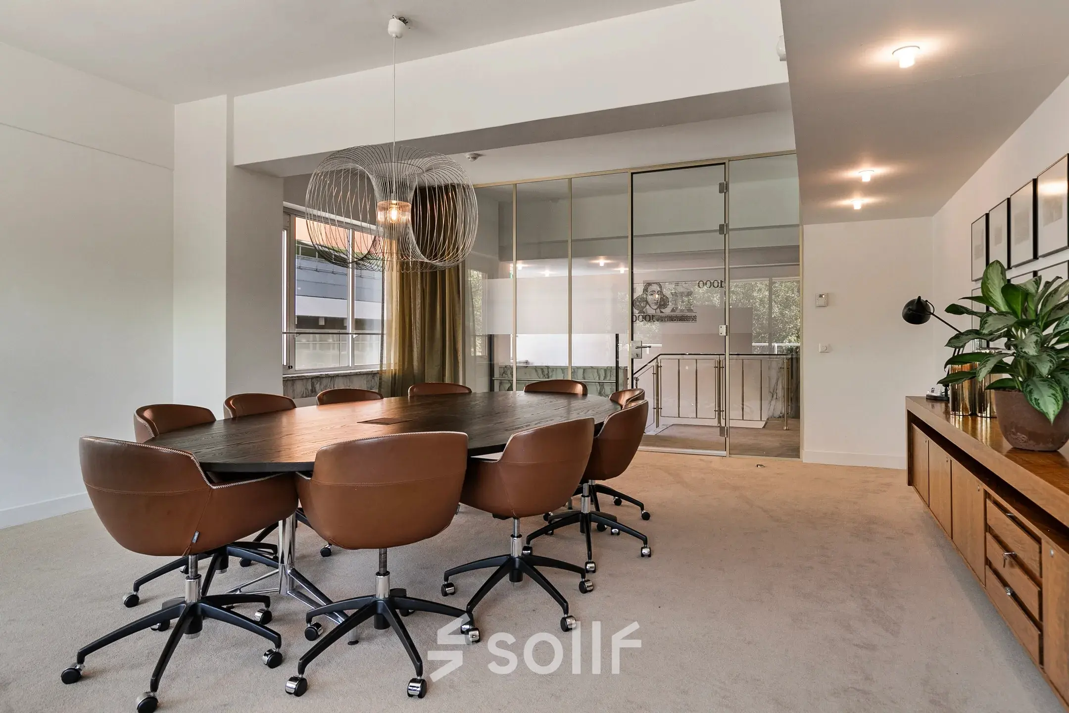 Spacious conference room at Coolsingel 104, Rotterdam Center, featuring a large oval table with comfortable chairs, ideal for office space rental.