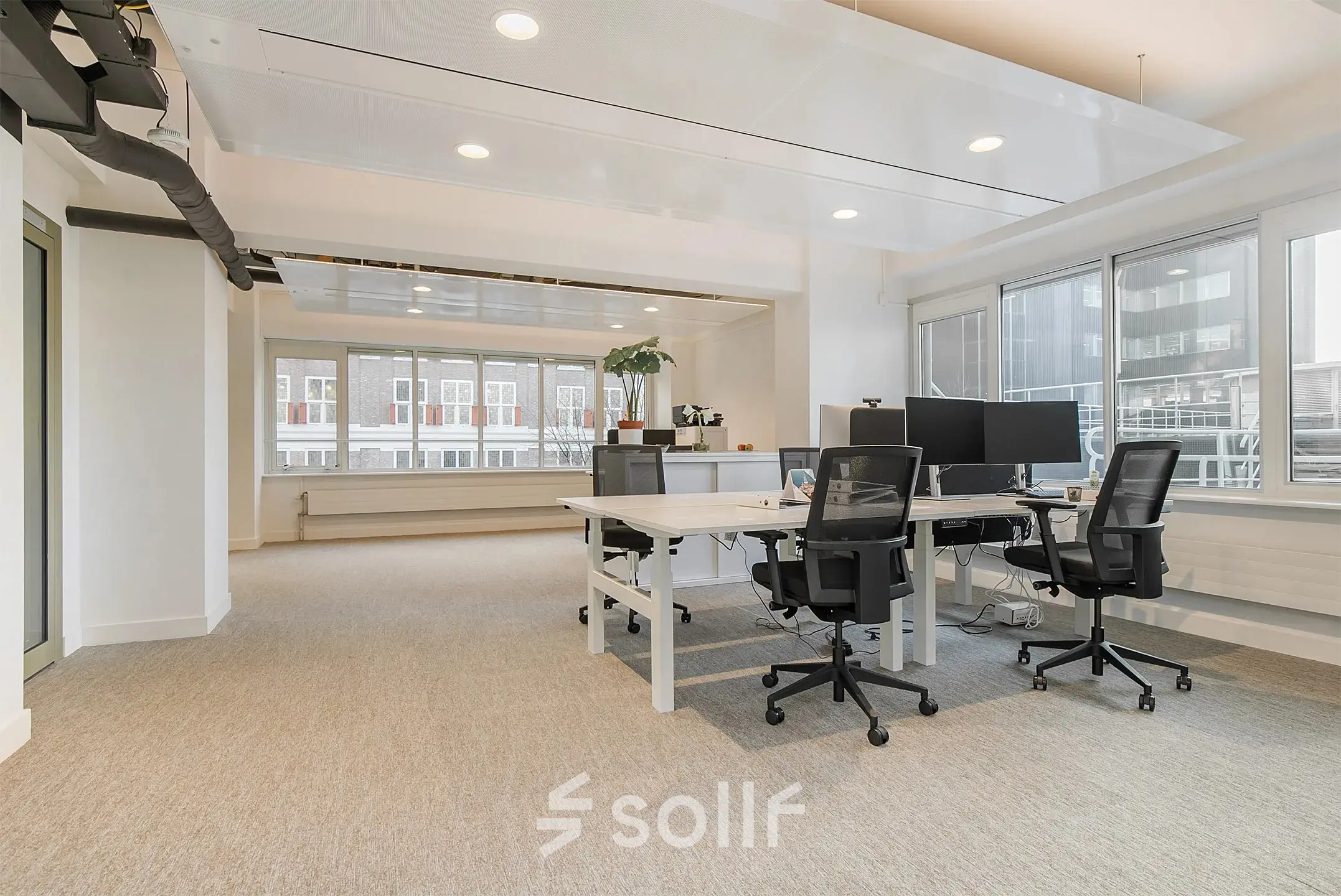 Bright and airy office space for rent at Coolsingel 104, Rotterdam Center, featuring modern furnishings and large windows providing ample natural light.