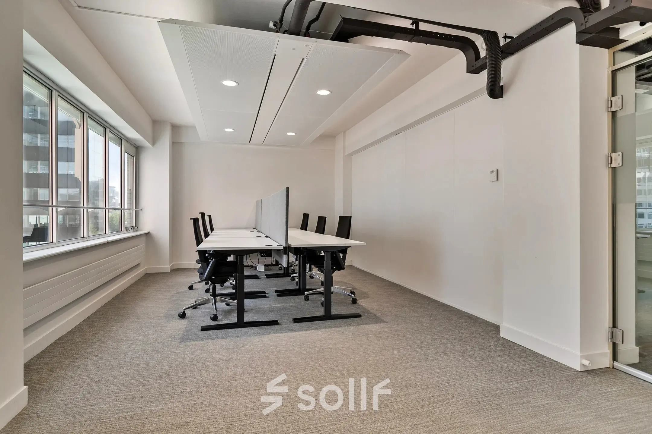 Bright office space at Coolsingel 104 in Rotterdam Center featuring rows of desks and chairs ideal for office space rental.