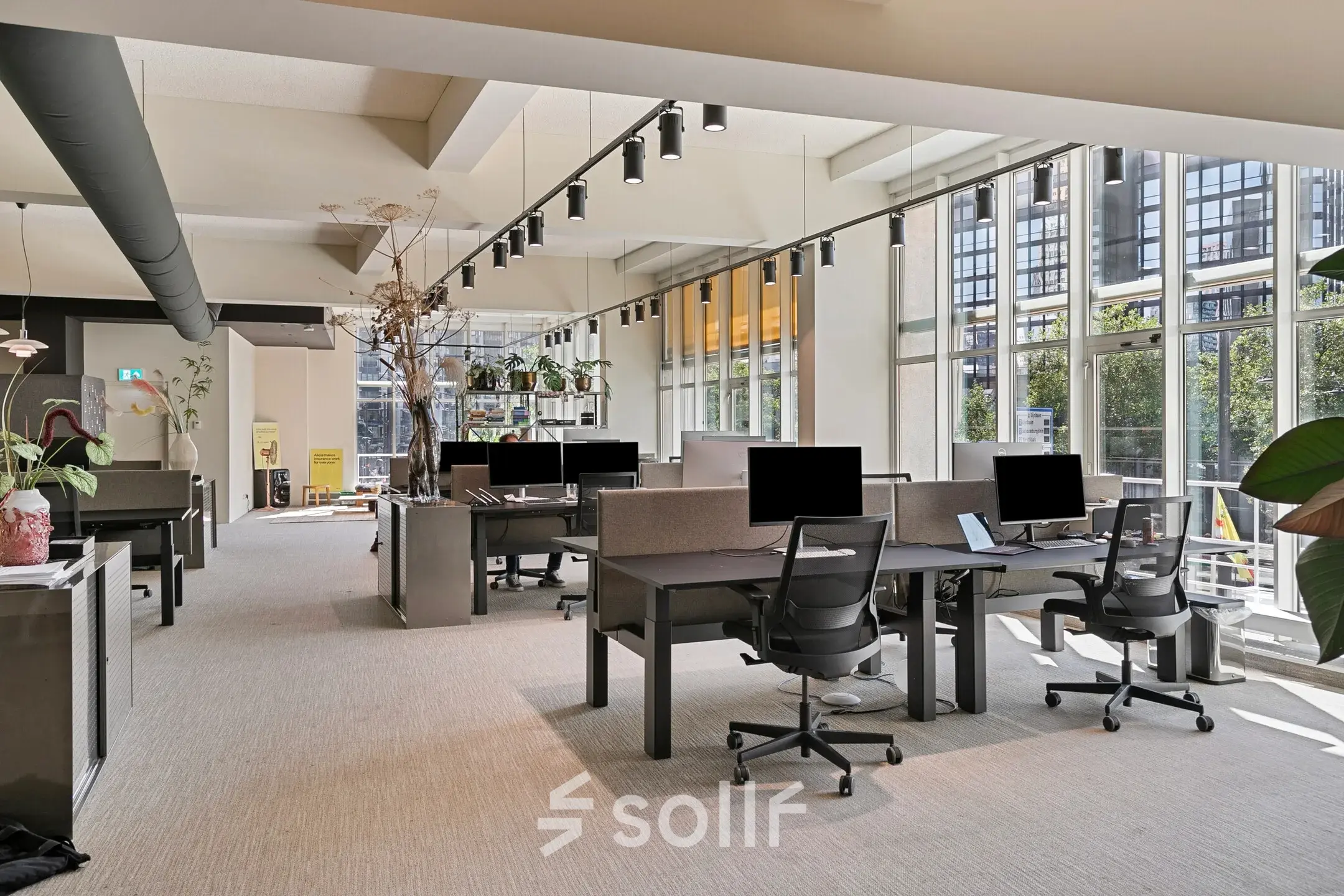 Spacious office at Coolsingel 104 in Rotterdam Center features furnished workstations under modern lighting, ideal for rent office space. Large windows allow plenty of natural light.