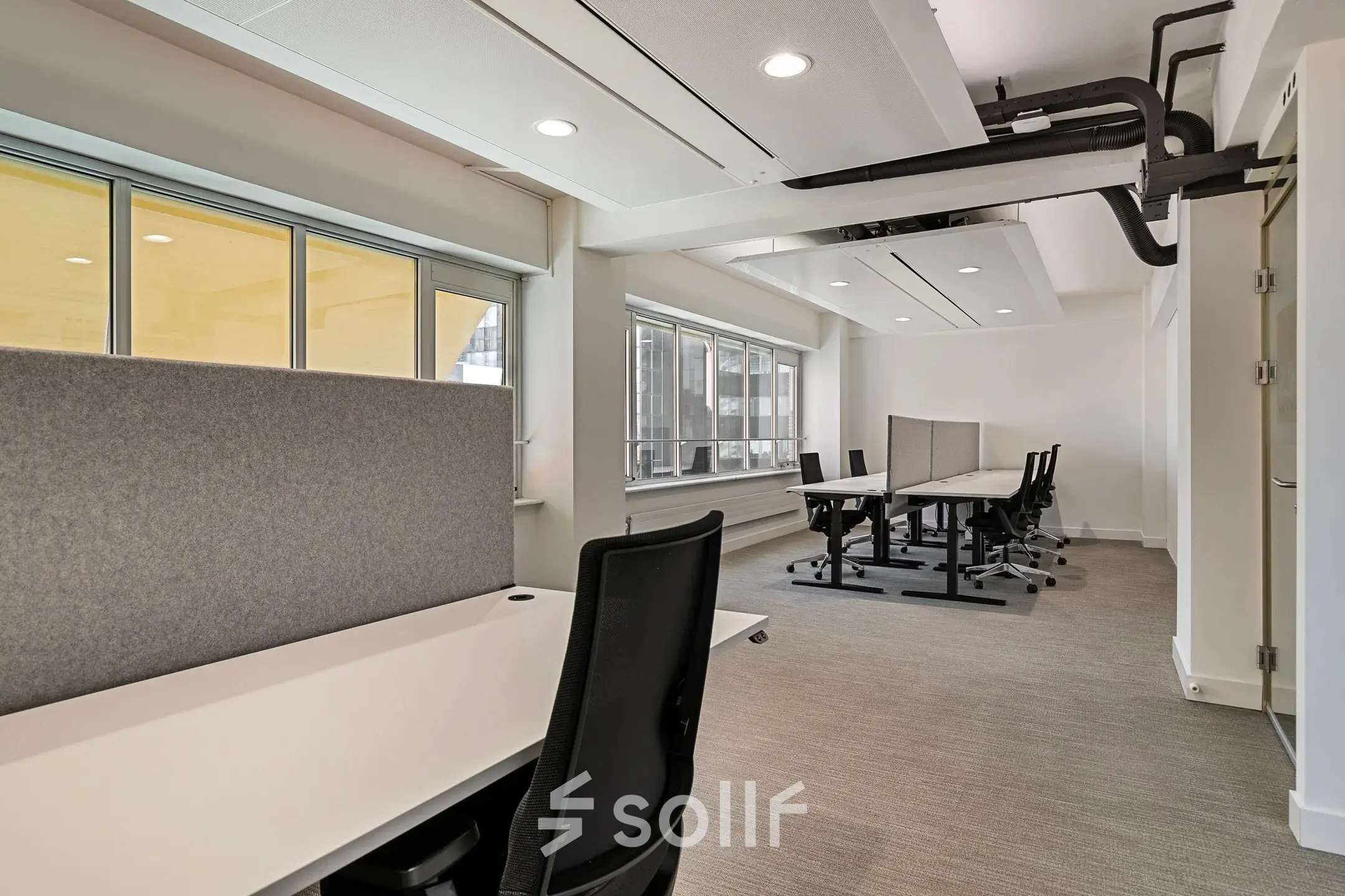 Modern office space in Rotterdam Center at Coolsingel 104, featuring natural light and furniture, ideal for office space rental.