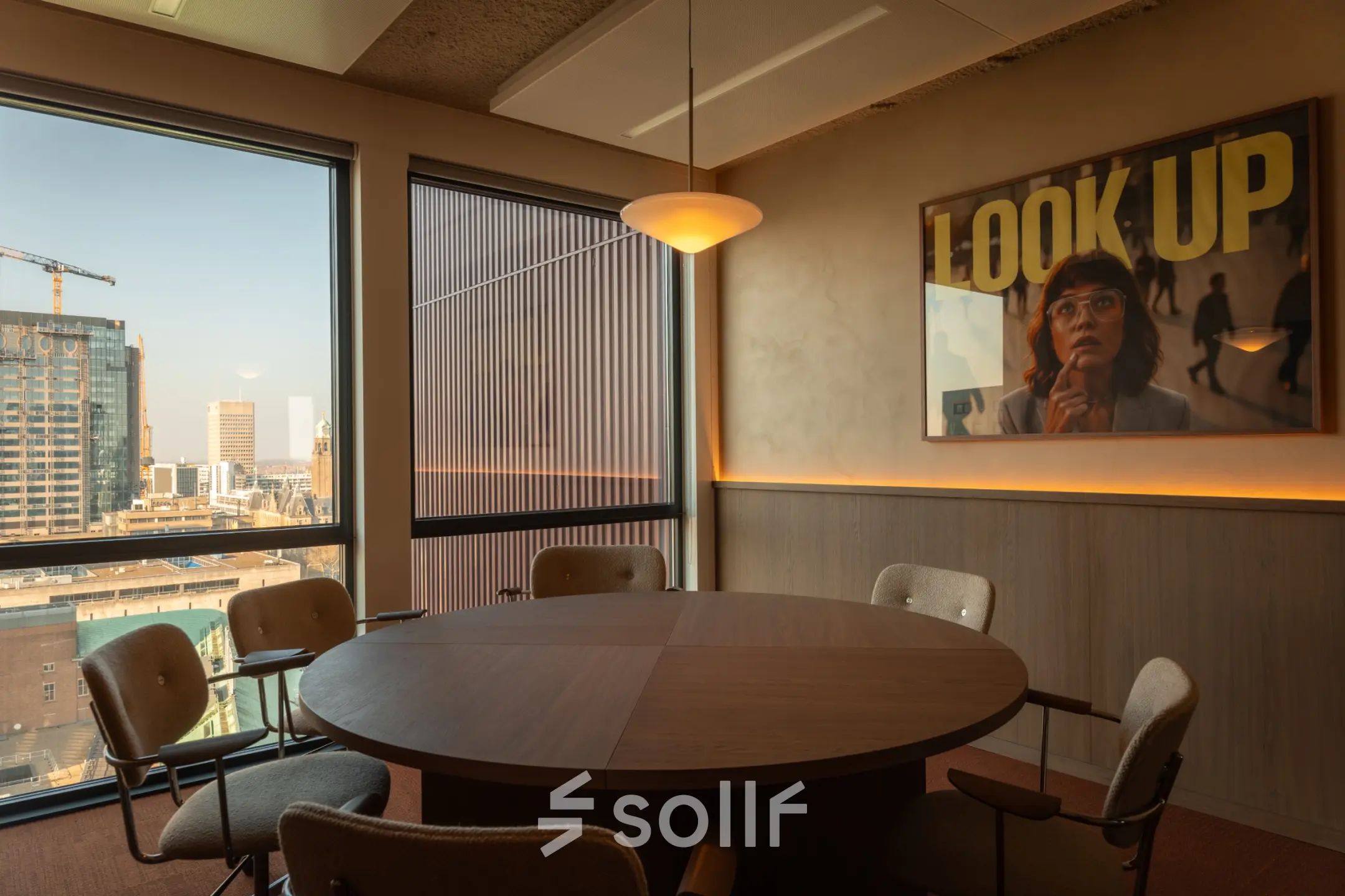 Cozy conference room at Coolsingel 139, Rotterdam Center with a large round table and city views, ideal for office space rental.