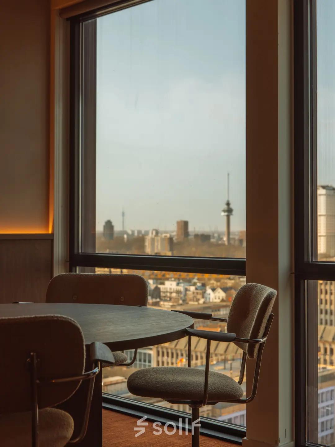 Furnished office space at Coolsingel 139, Rotterdam Center, featuring large windows with a city view, ideal for rent office space with functional work areas.