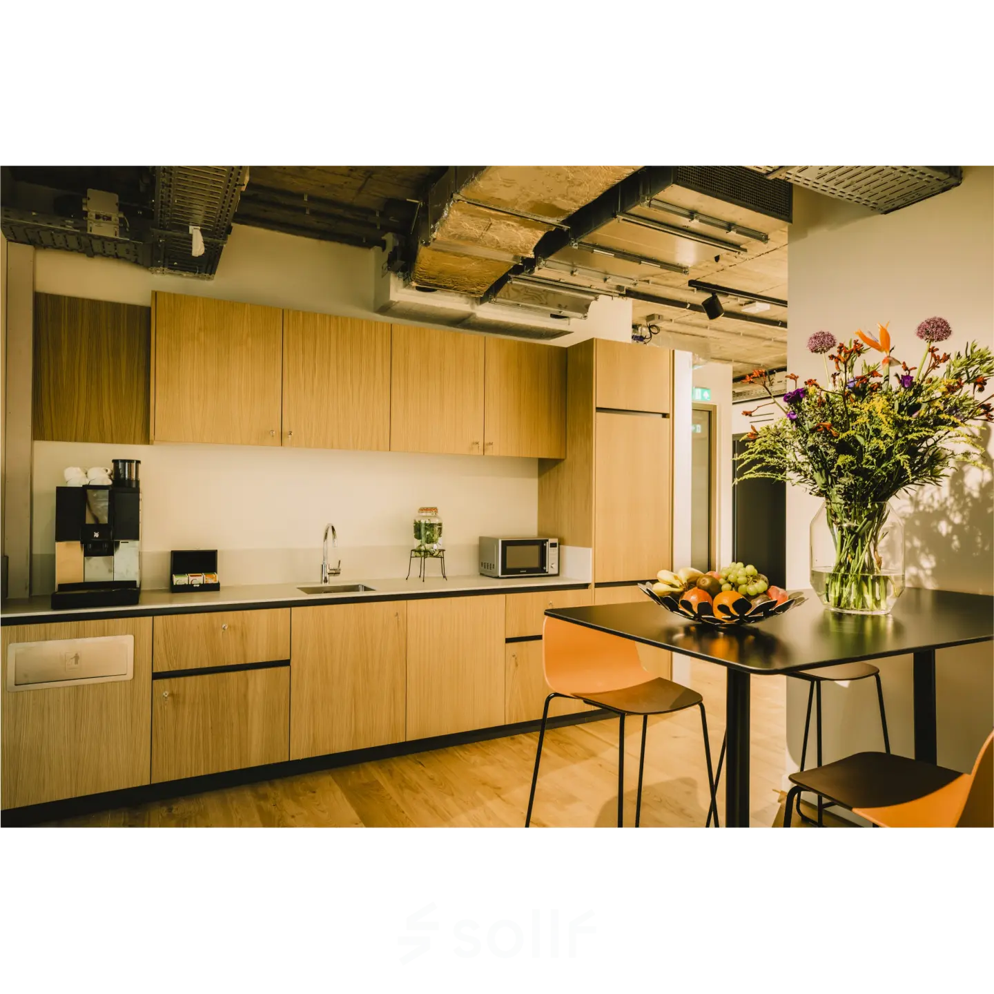 Modern furnished pantry at Coolsingel 65, Rotterdam Center, featuring sleek cabinets and a coffee machine, available for office space rental.