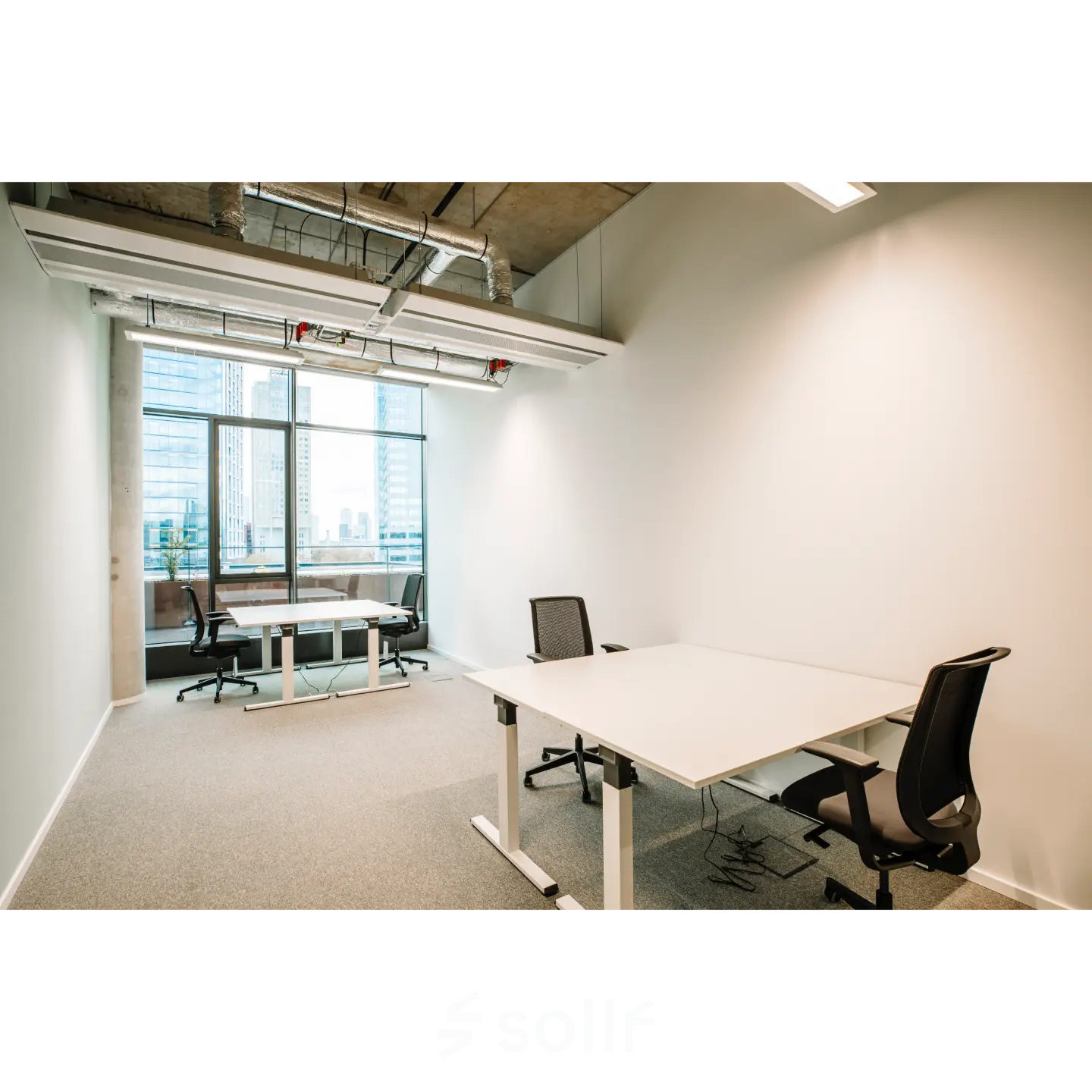 Bright office space for rent at Hoogstraat 185, Rotterdam Center featuring modern furnishings and large windows for natural light.