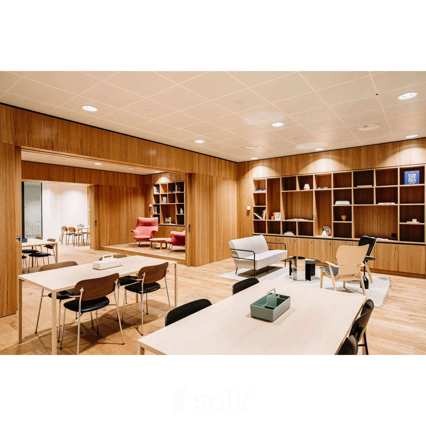 A modern office space to rent on Hoogstraat 185, Rotterdam Center, featuring sleek wooden decor with tables and chairs, ideal for office space rental.