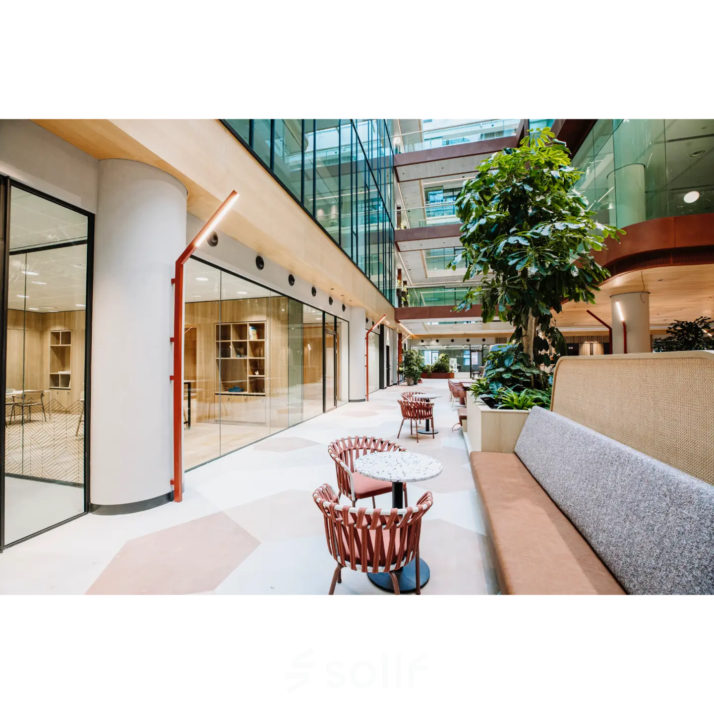 Bright office space to rent in Rotterdam Center, featuring modern interior with seating and glass walls, perfect for collaborative work environments.