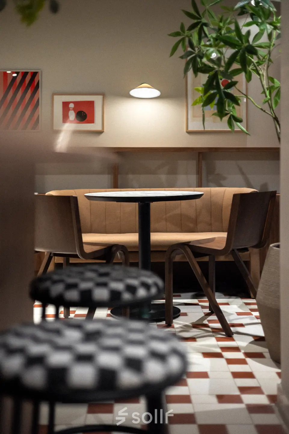 Stylish office space with a cozy seating area featuring modern chairs and artwork. Ideal for office space rental.