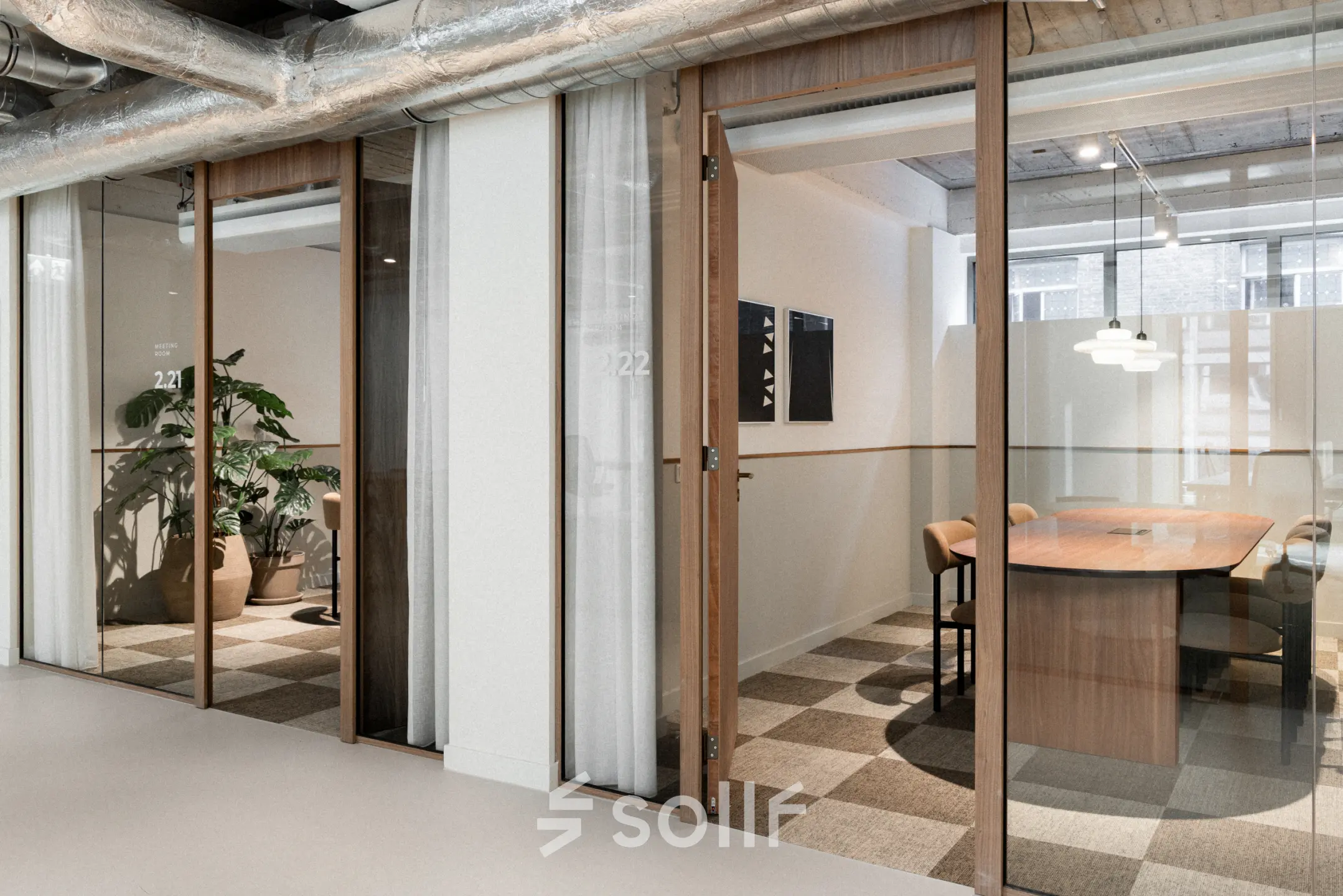 Modern office to rent at Stadhuisplein 9-23, Rotterdam Center, featuring glass-walled workspaces and stylish furnishings, ideal for productive meetings and collaborations.