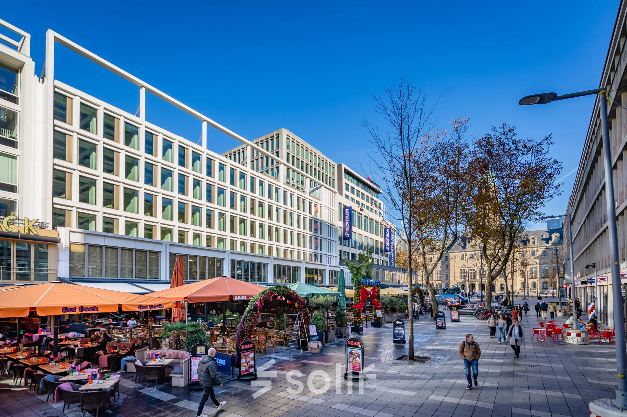 View of Stadhuisplein 9-23 in Rotterdam Center, showing a bustling outdoor scene with nearby office spaces to rent.