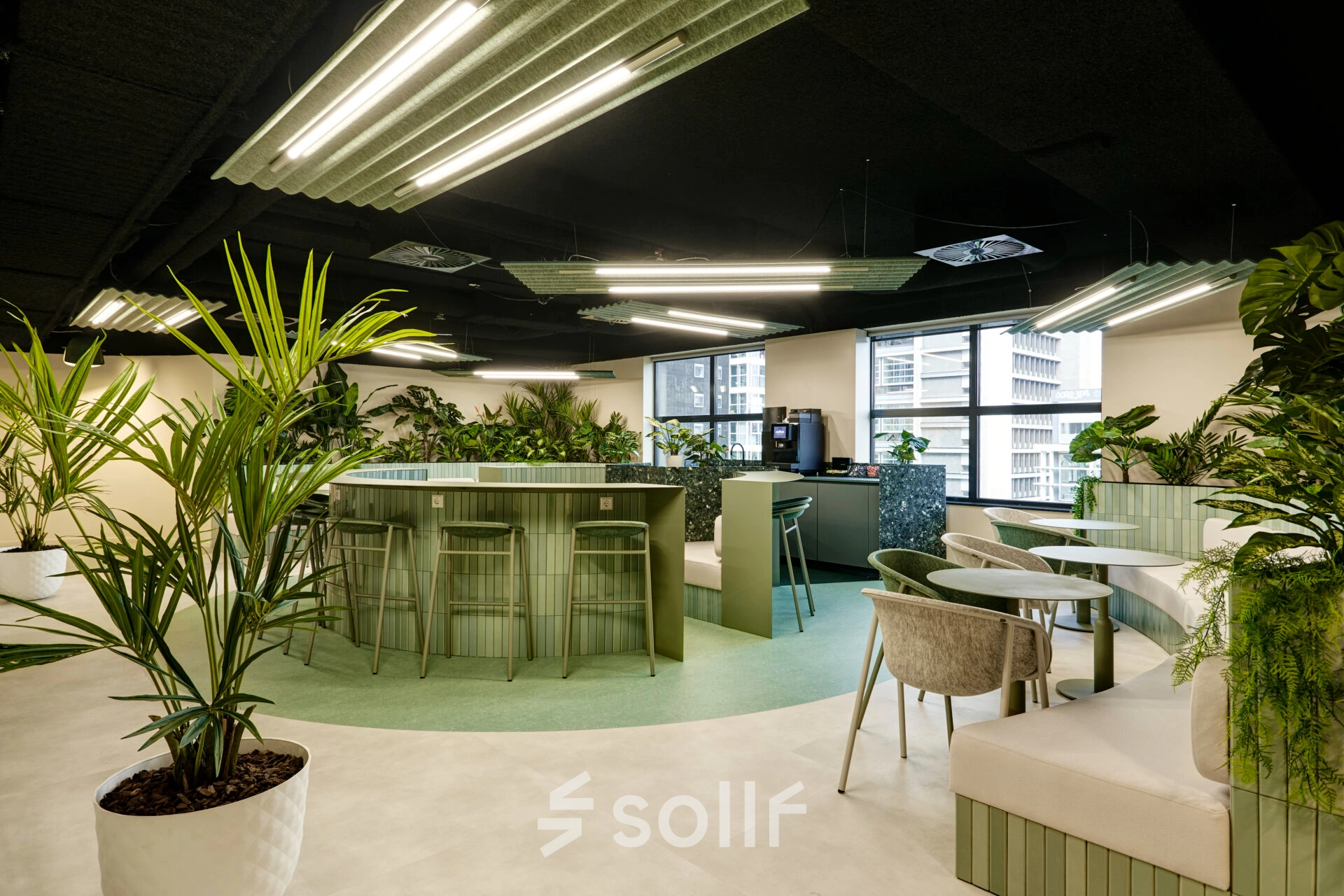 Modern furnished office space for rent at Weena 335, Rotterdam Center, featuring sleek tables and lush plants, ideal for workspaces.