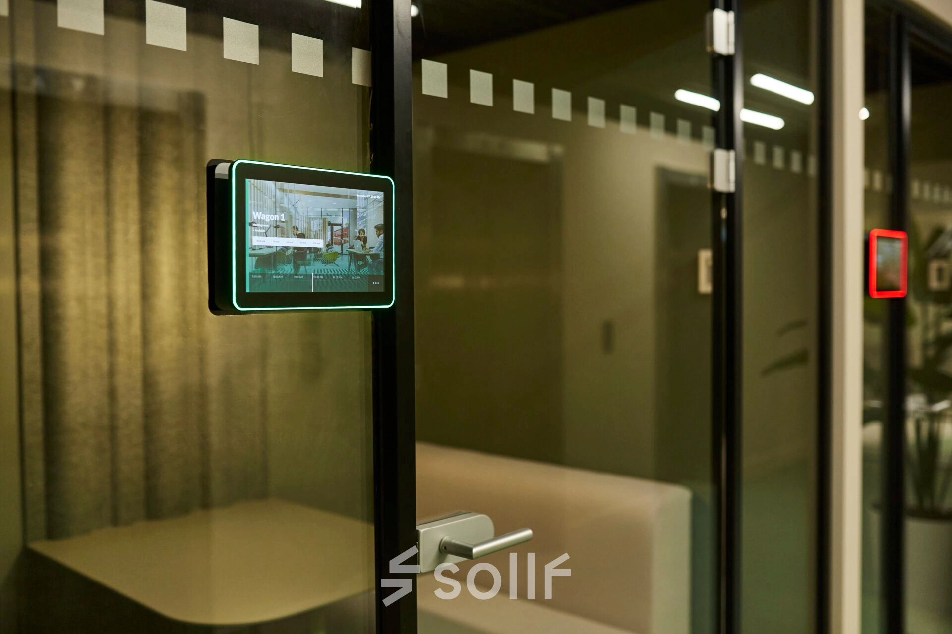 Modern office space rental with glass partitions in Rotterdam Center at Weena 335. A visible meeting room tablet signifies a high-tech workspace ambiance. Ideal for those seeking an office to rent.