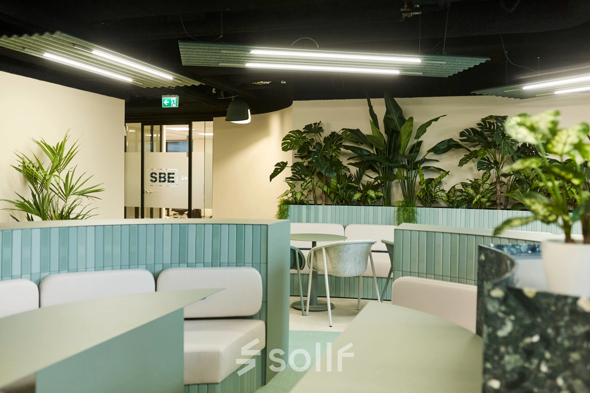 Modern office to rent at Weena 335, Rotterdam Center featuring stylish seating areas with greenery, ideal for office space rental.