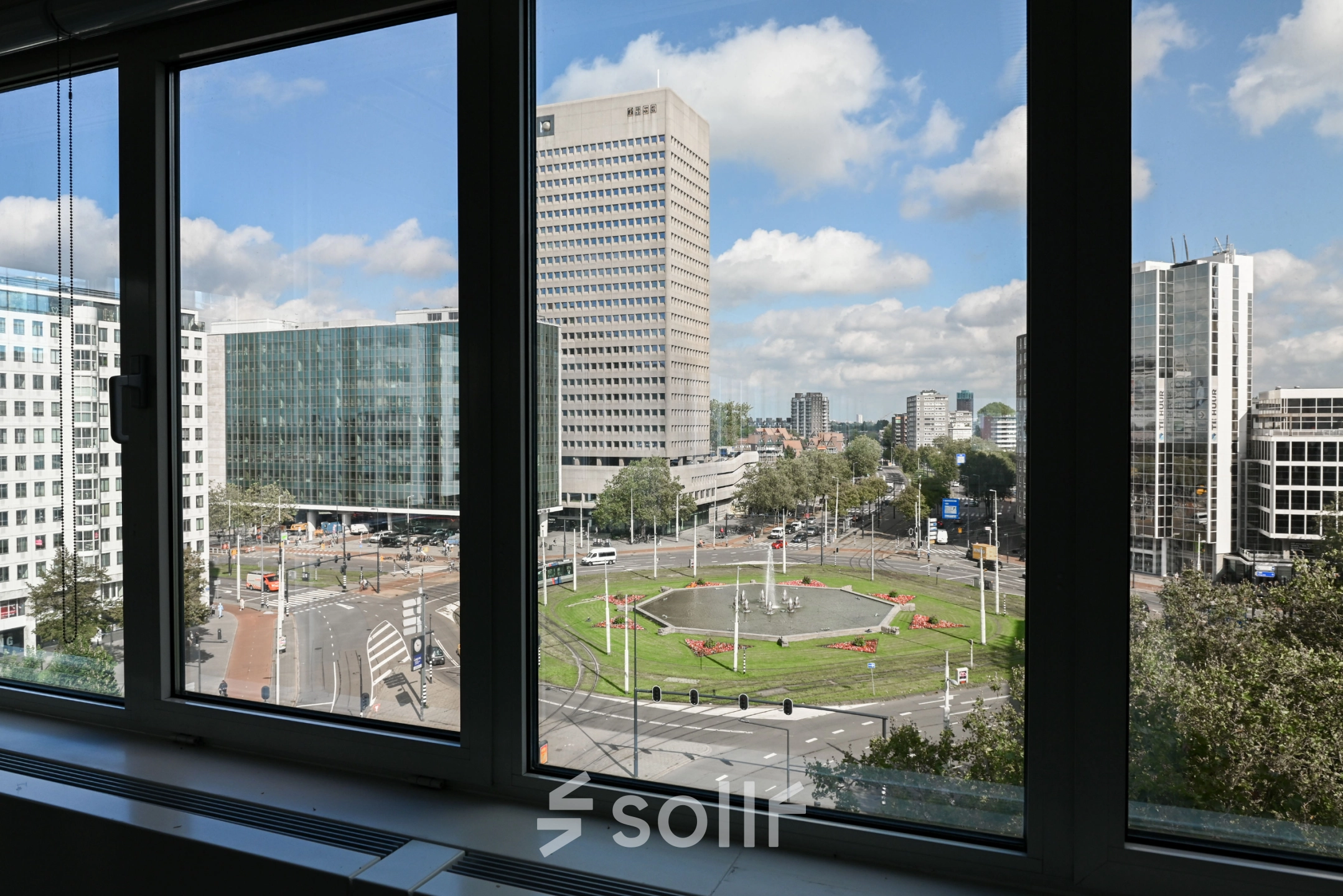 View from an office window at Weena 70, overlooking Rotterdam Center's bustling streets, ideal for office space rental.