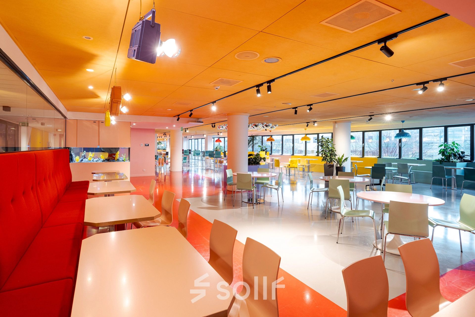 Bright and colorful workspace at Weena 70, Rotterdam Center with modern furniture and open floorplan, ideal for office space rental.