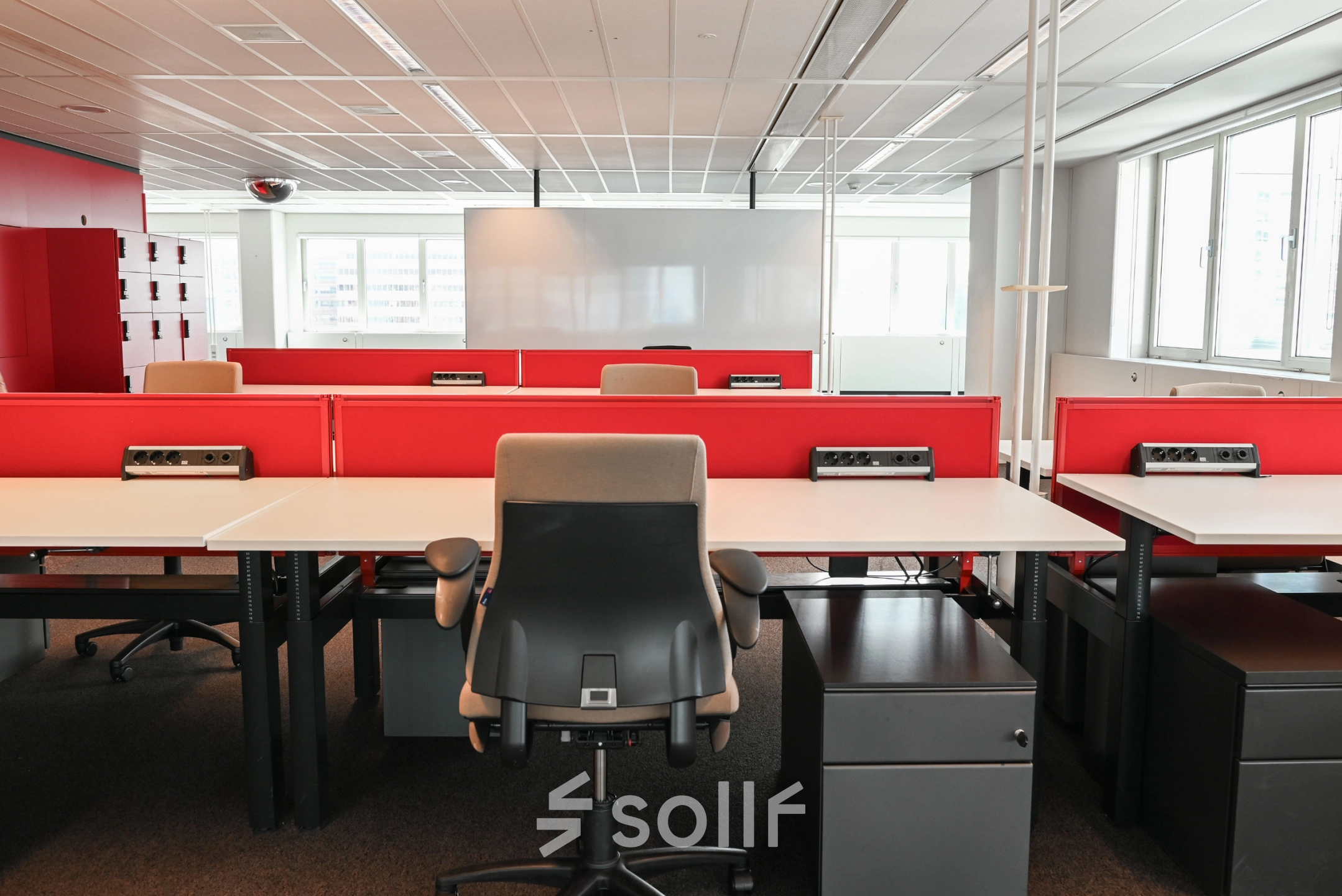 Spacious office to rent at Weena 70 in Rotterdam Center featuring organized workspaces with red dividers, ample natural light, and modern furnishings ideal for office space rental.