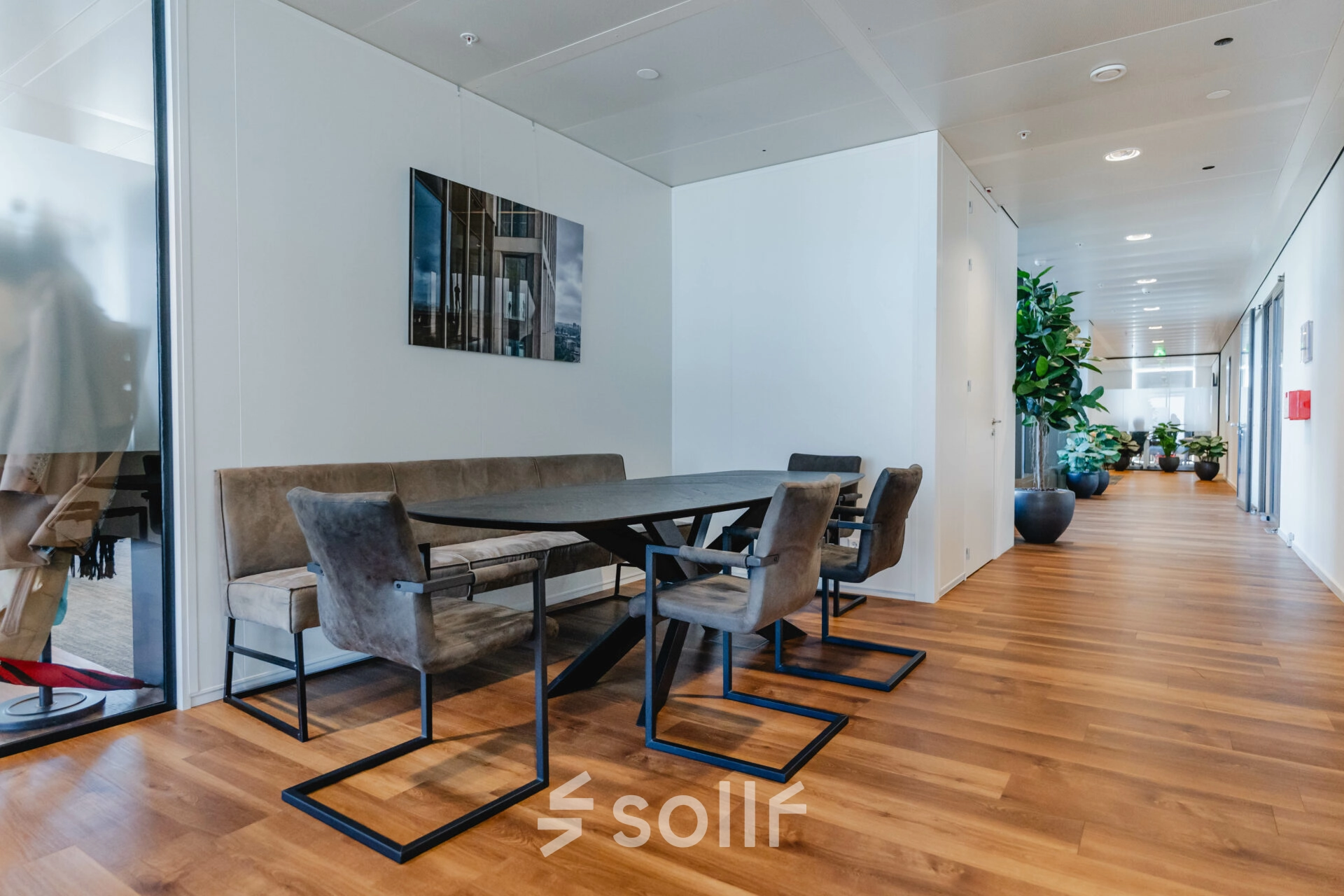 Furnished interior workspace at Weena 788, Rotterdam Center, featuring a sleek wooden table and modern chairs, perfect for rent office space needs.