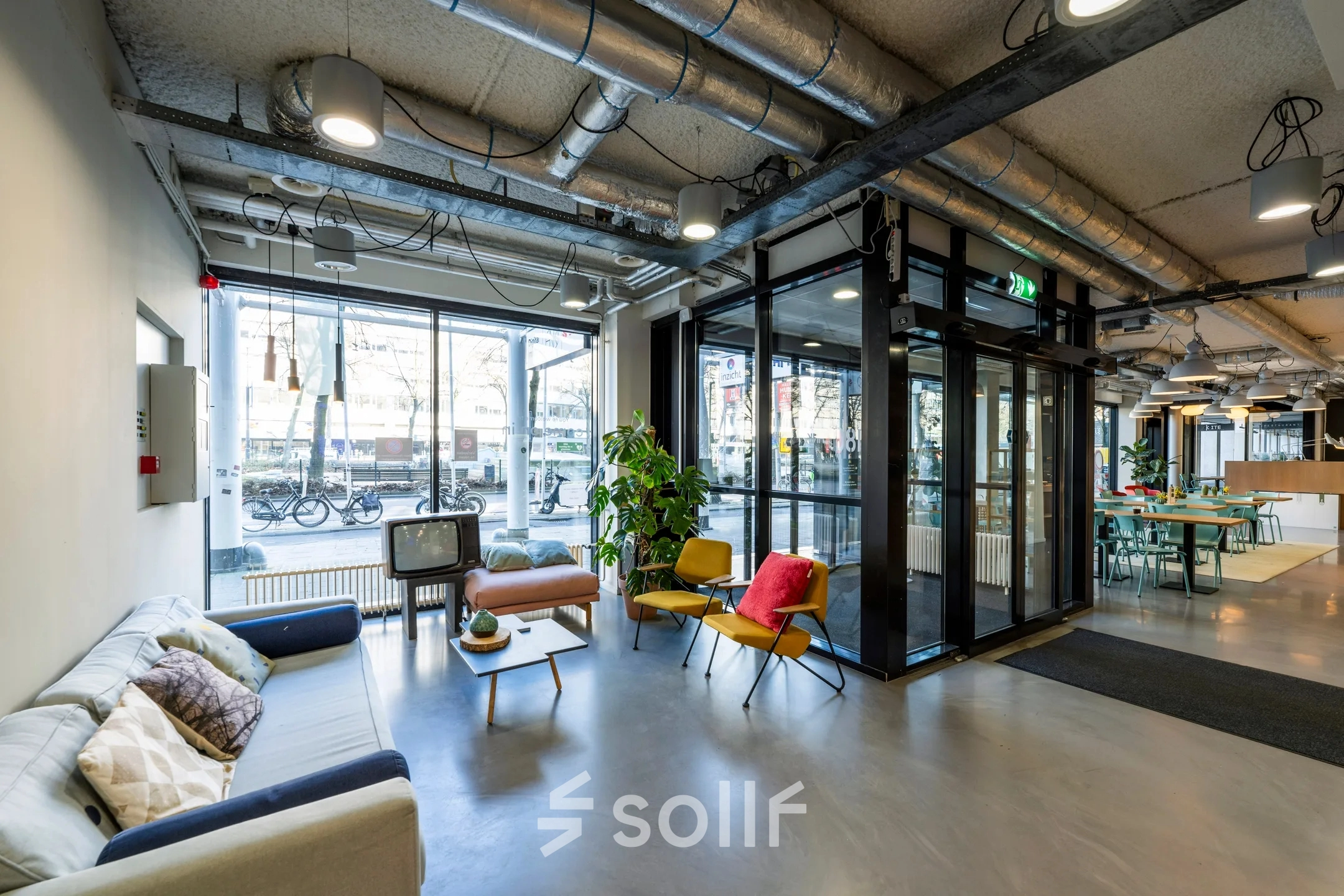 Stylish office lobby at Westblaak 180, Rotterdam Center, with bright seating, large windows, and industrial design, perfect for office space rental.
