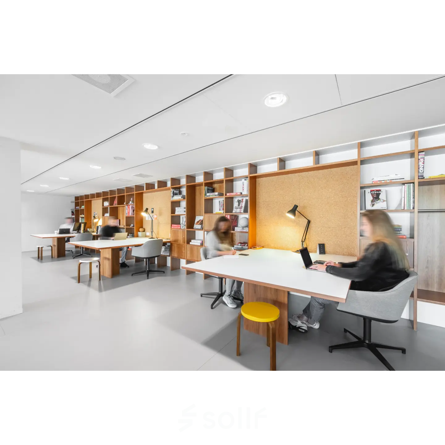 Modern office space for rent at Hofplein 20, Rotterdam Central Station with furnished workspaces and people engaged in business activities.