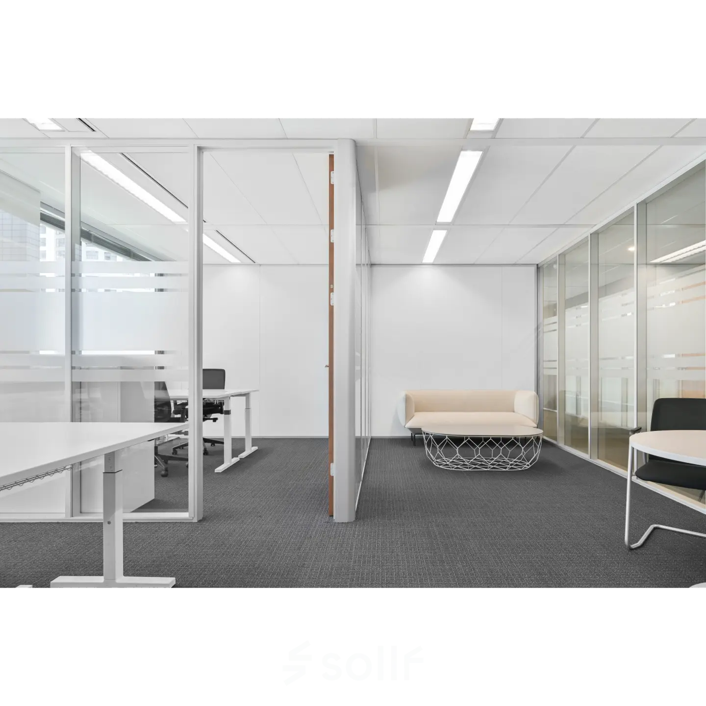 Modern office space at Weena 290, Rotterdam Central Station, features a furnished open design with desks and a lounge area, perfect for office space rental.