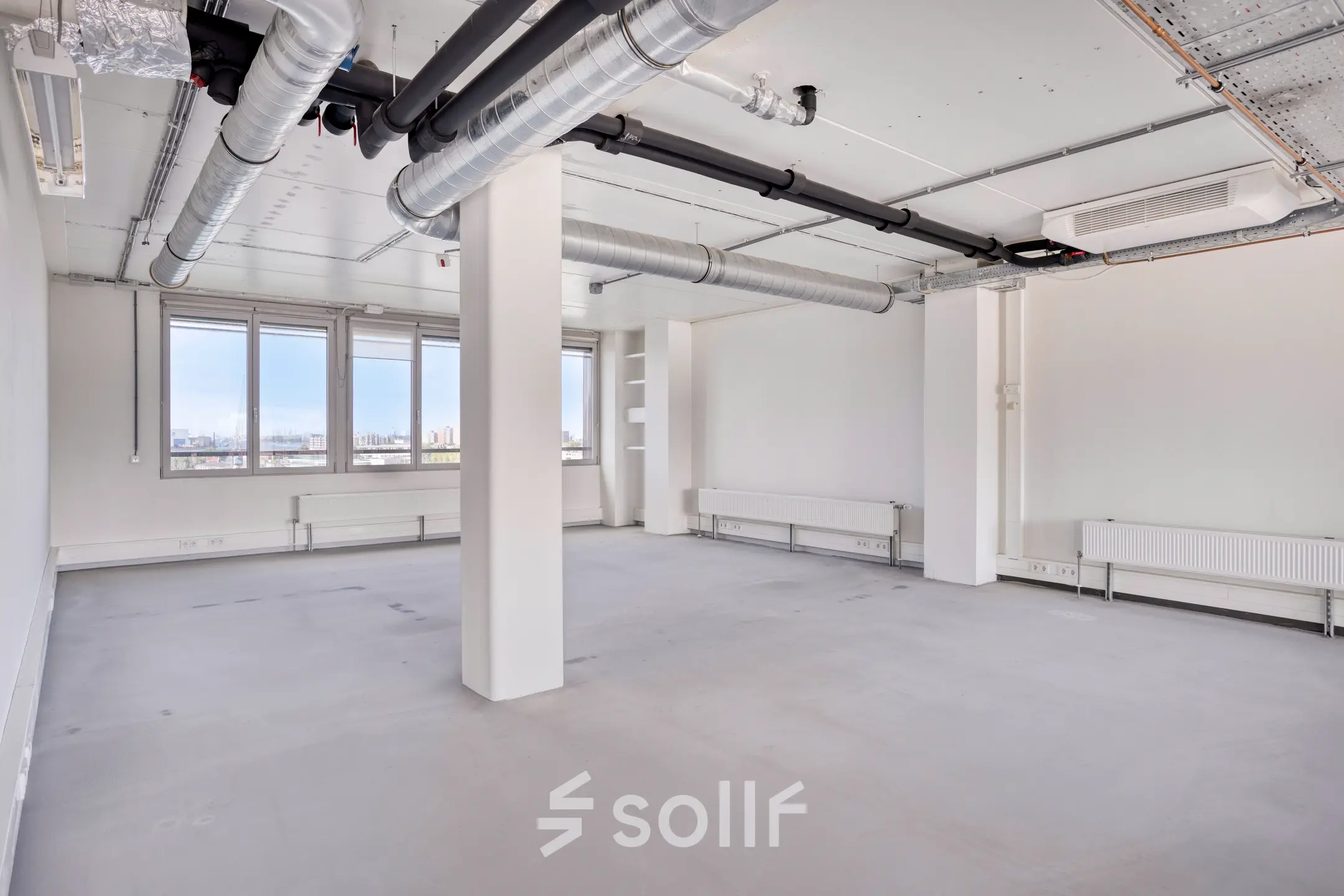 Interior view of an unfurnished office space at Kratonkade 7 - 27, Rotterdam Delfshaven, ideal for office space rental with large windows offering natural light.