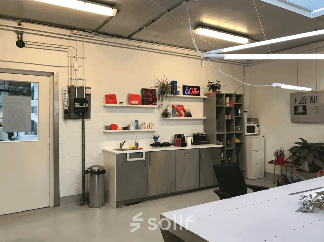 Furnished office space at Van Helmontstraat 17-23, Rotterdam Delfshaven, featuring a kitchenette with shelves, a microwave, and a coffee maker, ideal for your next office space rental.