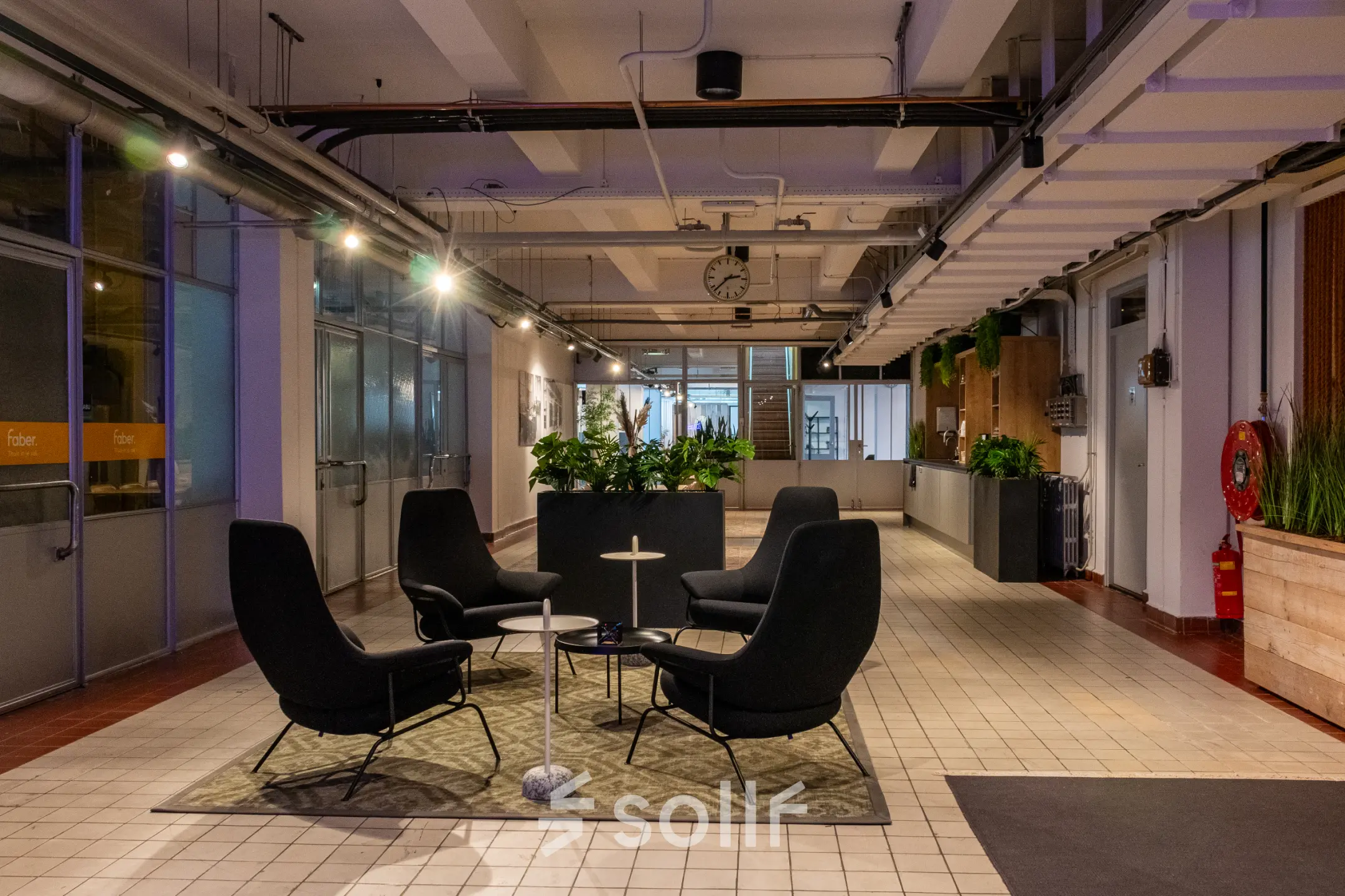 Modern office space at Van Nelleweg 1 in Rotterdam Delfshaven, featuring contemporary furniture and ample lighting, ideal for office space rental.