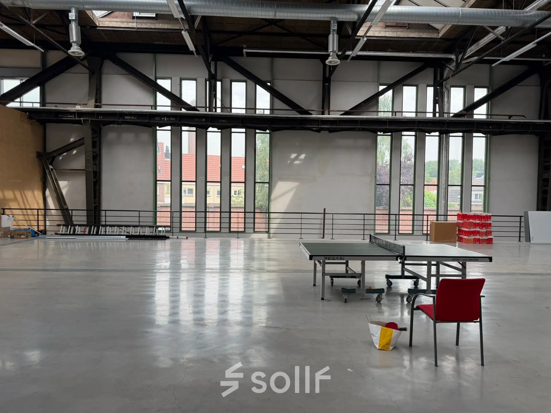 Spacious open floor plan at Scheepsbouwweg 29, Rotterdam Waalhaven, featuring large windows and minimal furnishings.
