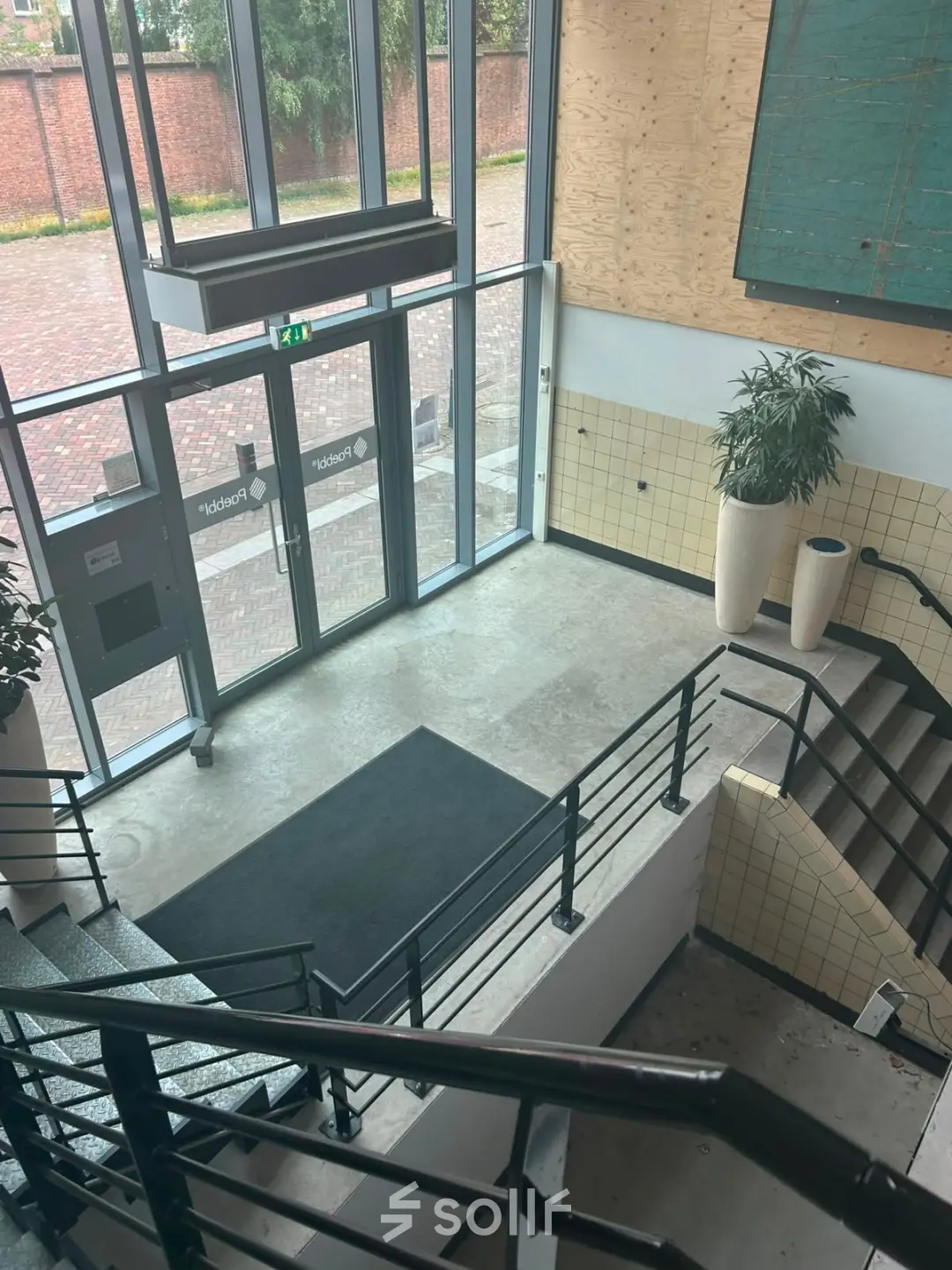Empty office entrance area at Scheepsbouwweg 29, Rotterdam Waalhaven, featuring modern design elements suitable for office space rental.