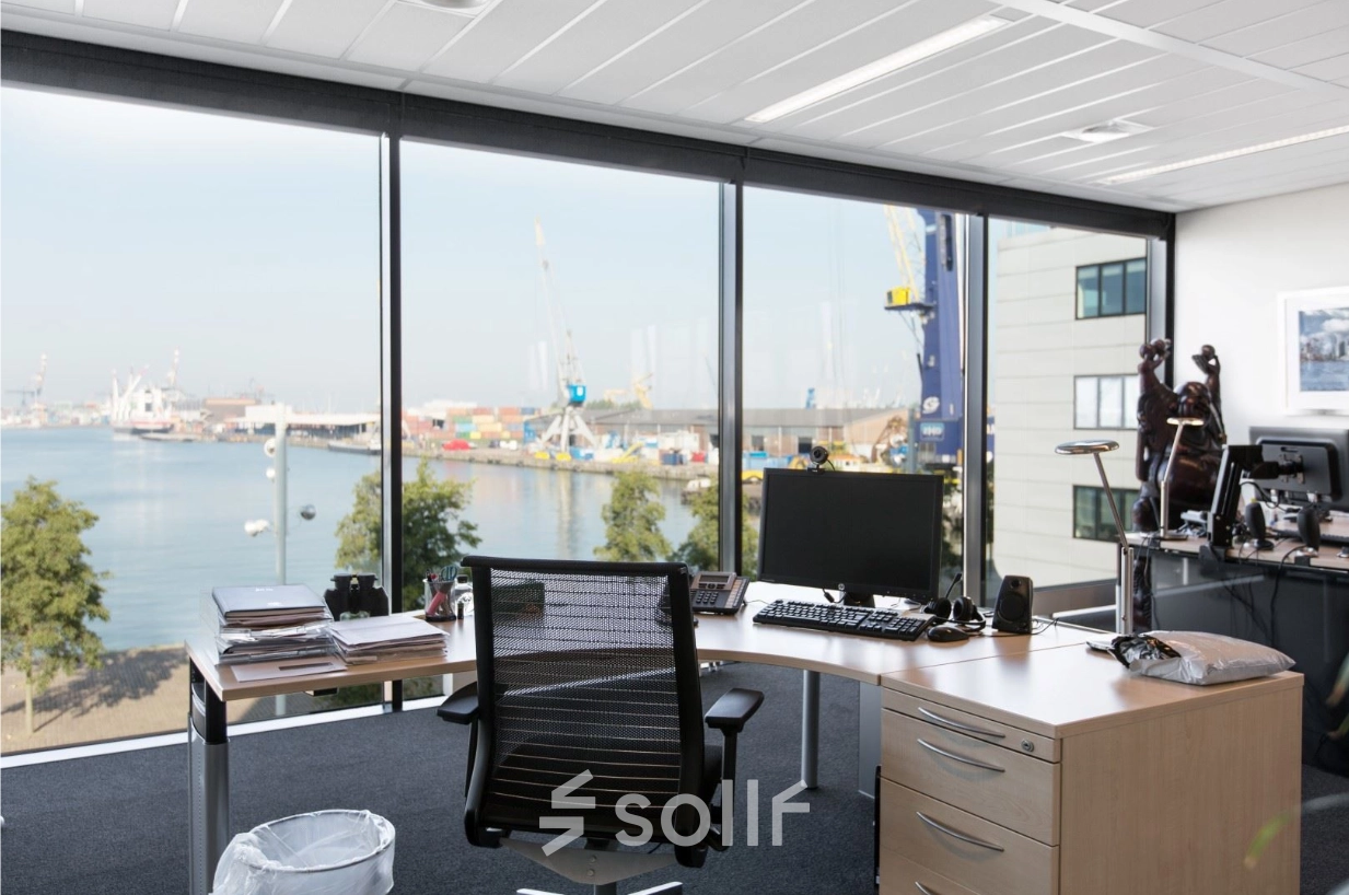 Bright office space at Waalhaven O.z. 83, Rotterdam Waalhaven, featuring a modern desk setup with a scenic harbor view, ideal for office space rental.
