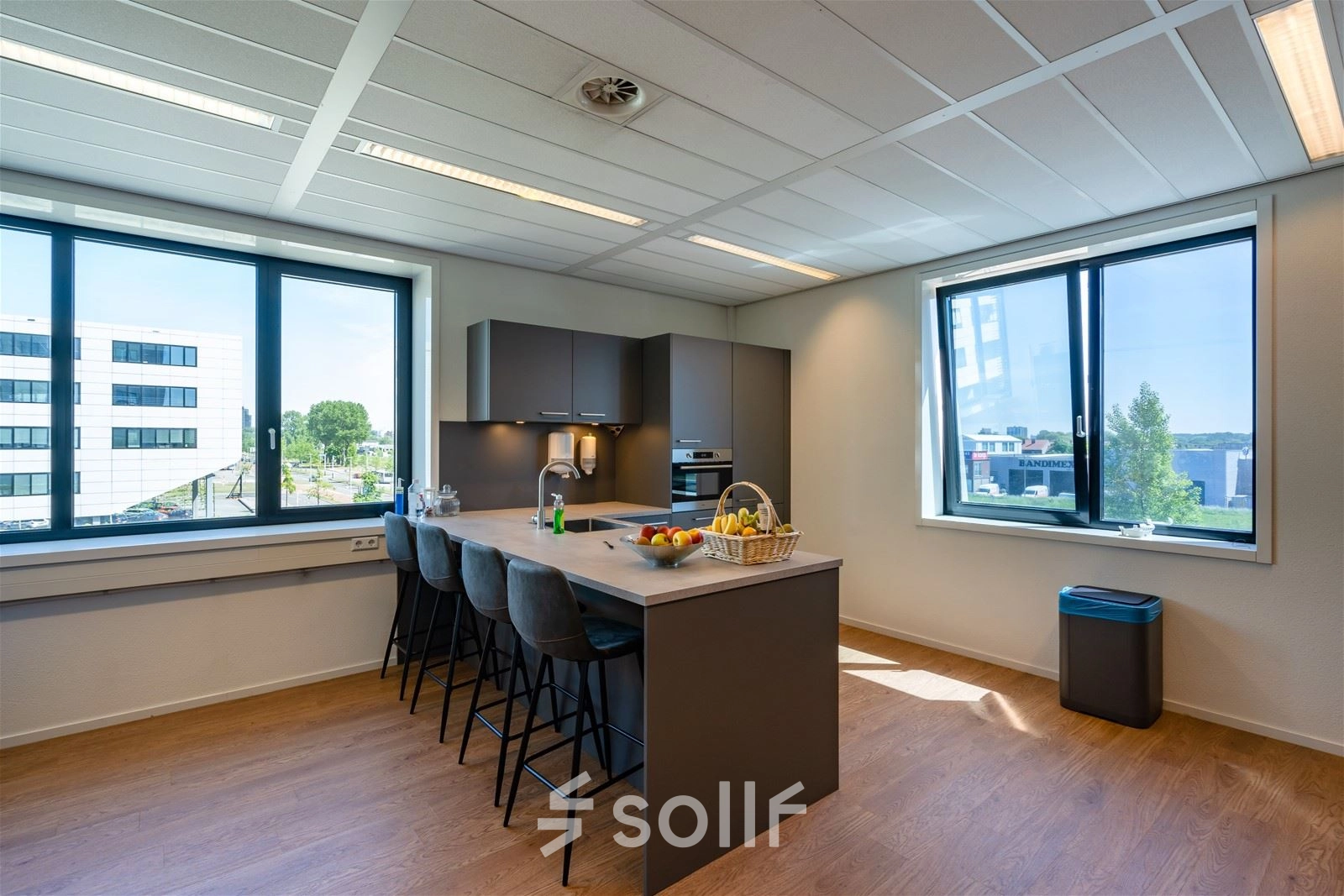 Bright office space featuring a modern pantry with bar stools and large windows at Waalhaven O.z. 83, Rotterdam Waalhaven, ideal for office space rental.