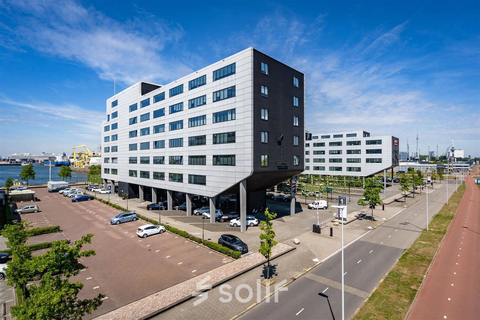 Office building exterior at Waalhaven O.z. 83 in Rotterdam Waalhaven with ample parking space, ideal for office space rental.