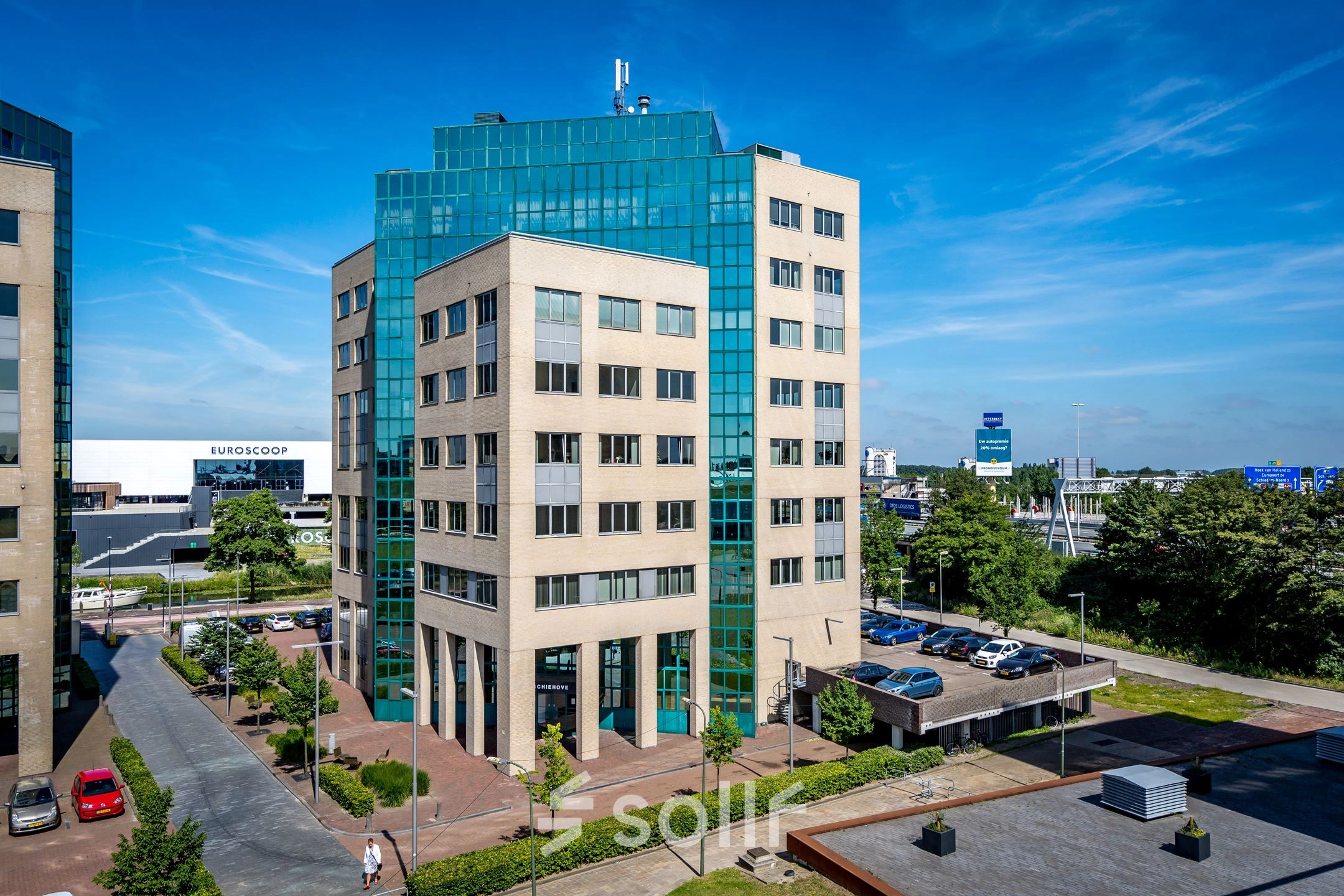 Modern office building exterior at Overschieseweg 304-332, Schiedam. The multi-story structure features large glass windows and a well-maintained surrounding area, ideal for office space rental.