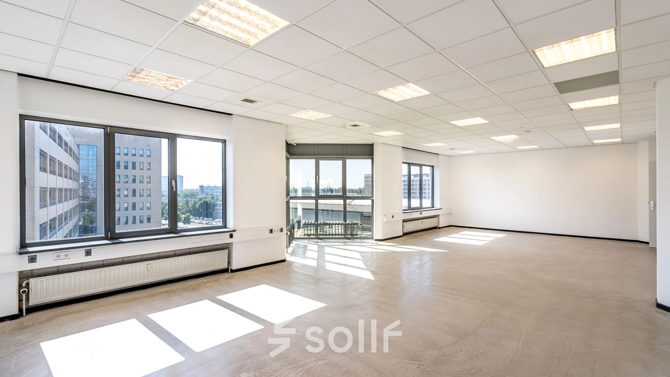 Spacious office interior at Overschieseweg 304-332, Schiedam, features large windows and ample natural light. Ideal for office space rental, offering a blank canvas for customization.