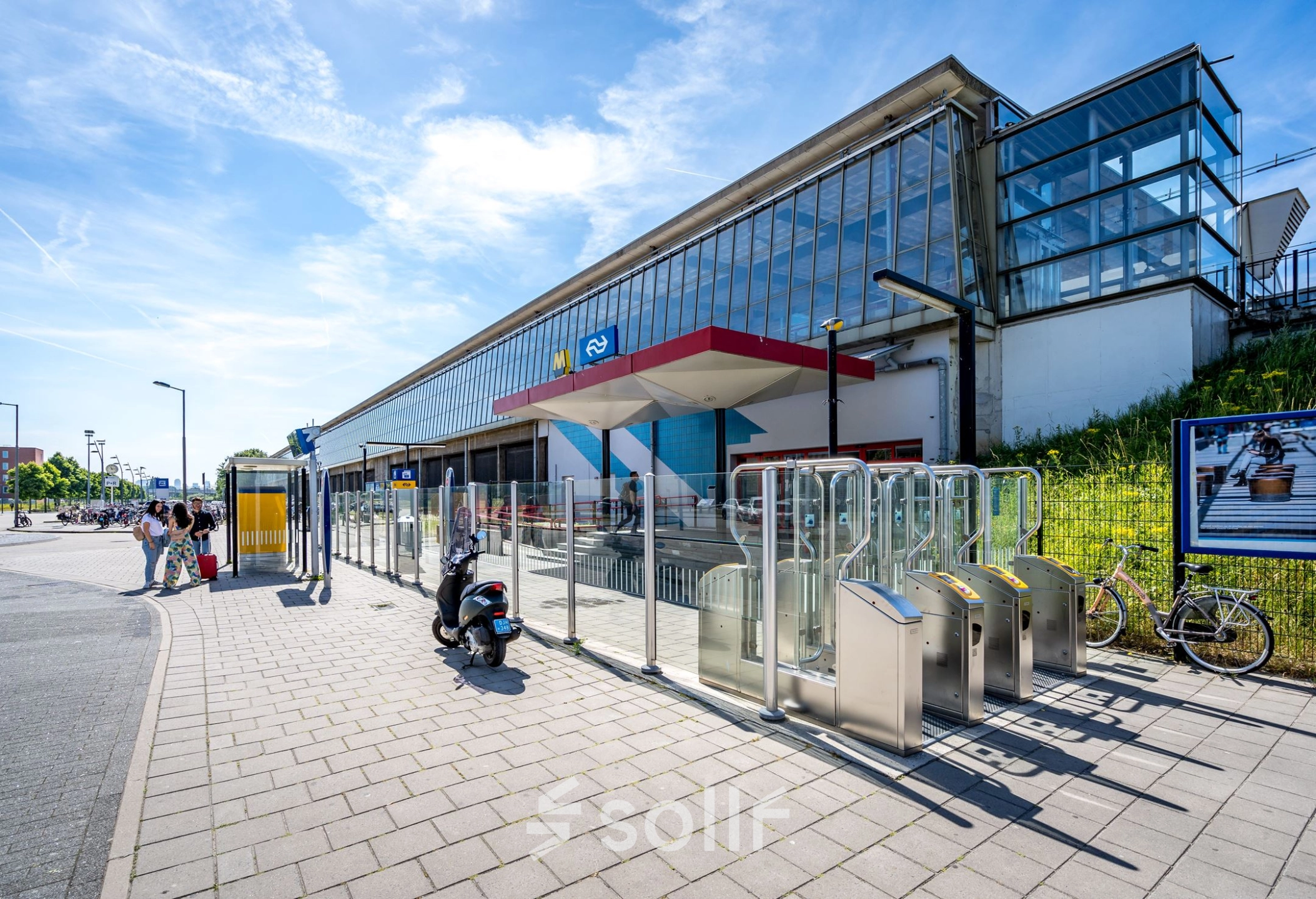 Exterior view of a modern office building located at Overschieseweg 304-332, Schiedam, with a sleek design and clear glass windows, perfect for office space rental.
