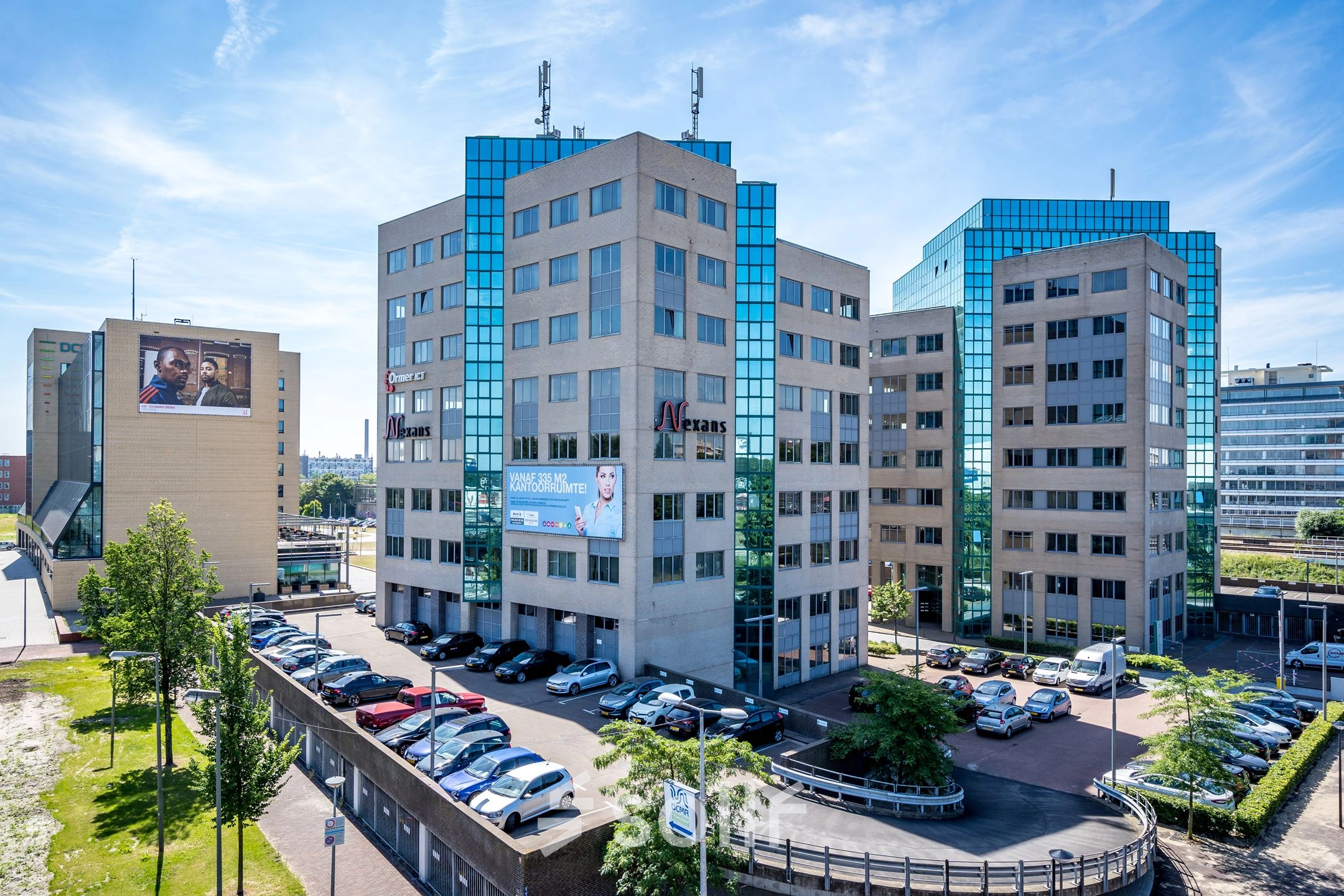Exterior view of modern office buildings at Overschieseweg 304-332 in Schiedam, featuring large glass windows and ample parking. Ideal for businesses seeking office space rental.